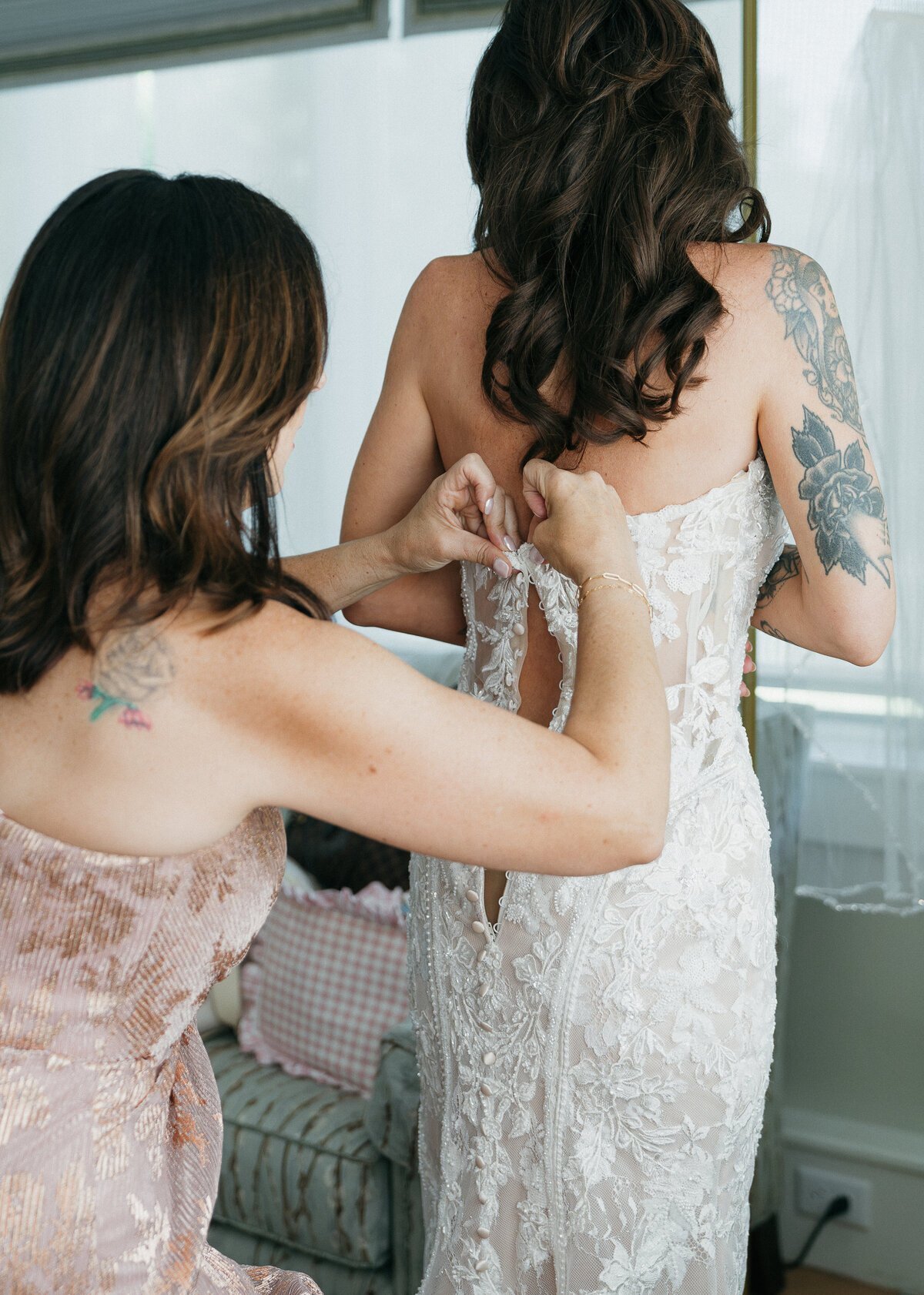 film style wedding photography by Shelby Ann Photos of bride dress buttoning