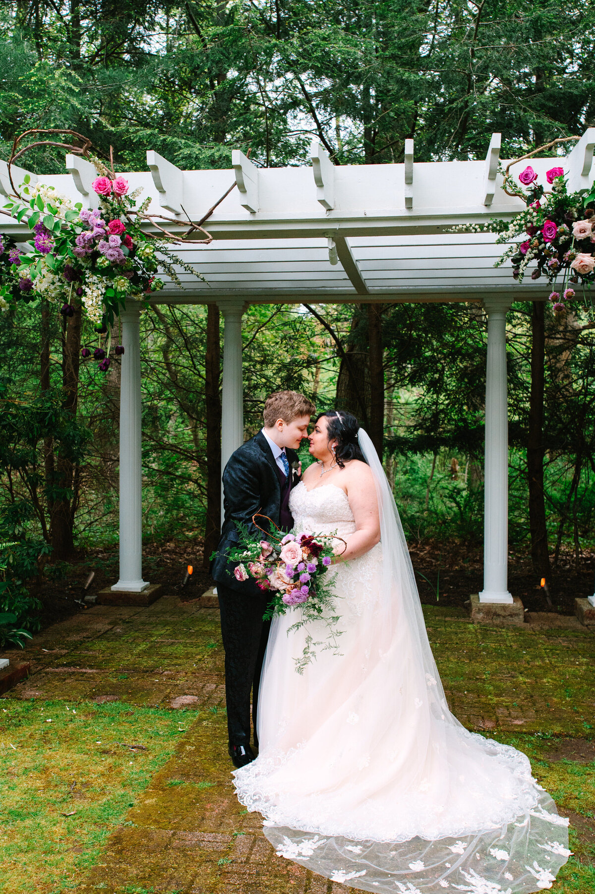 Brides smiling at each other leaning in