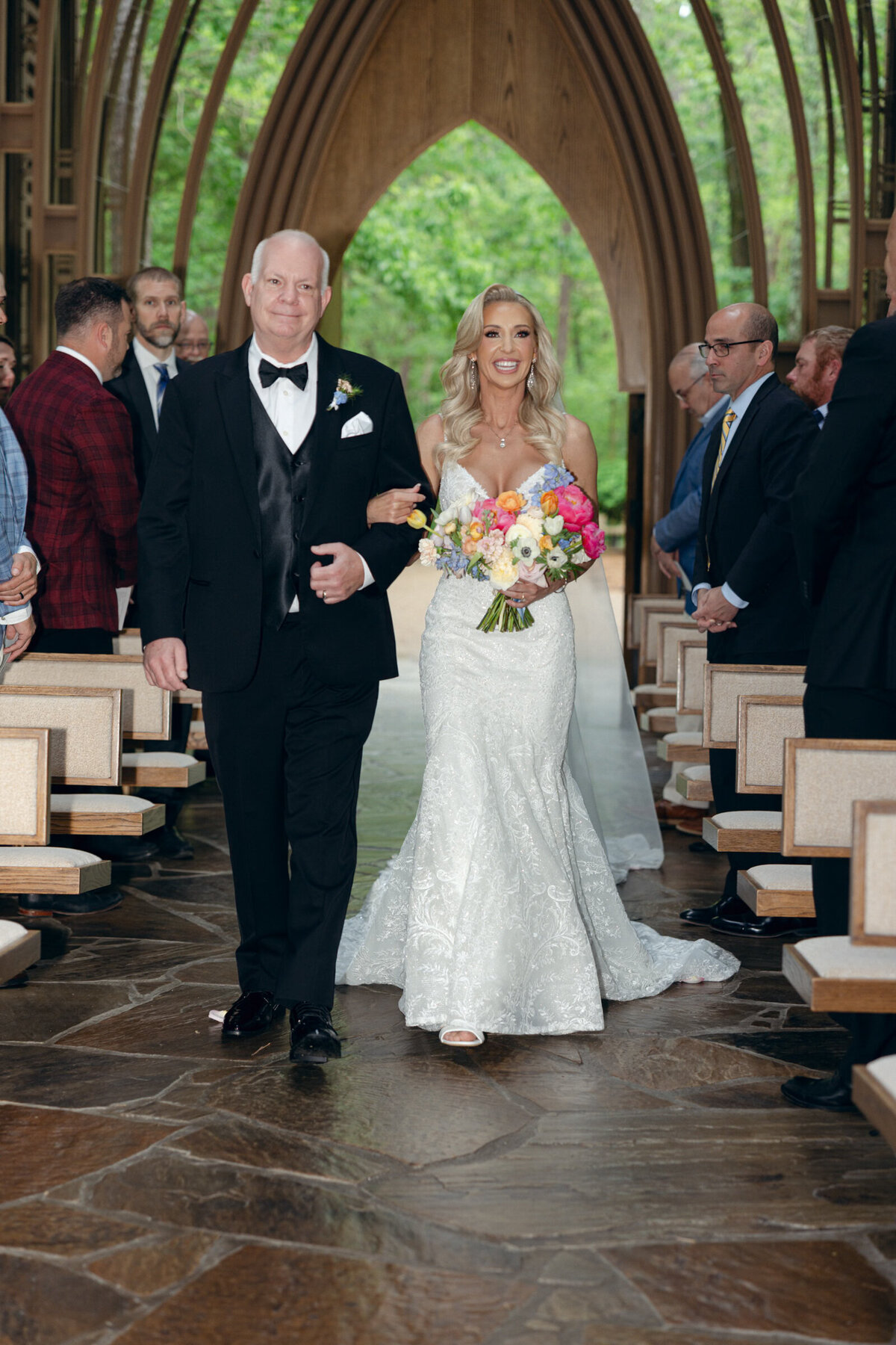 A wedding day photo of the bride walking down the aisle