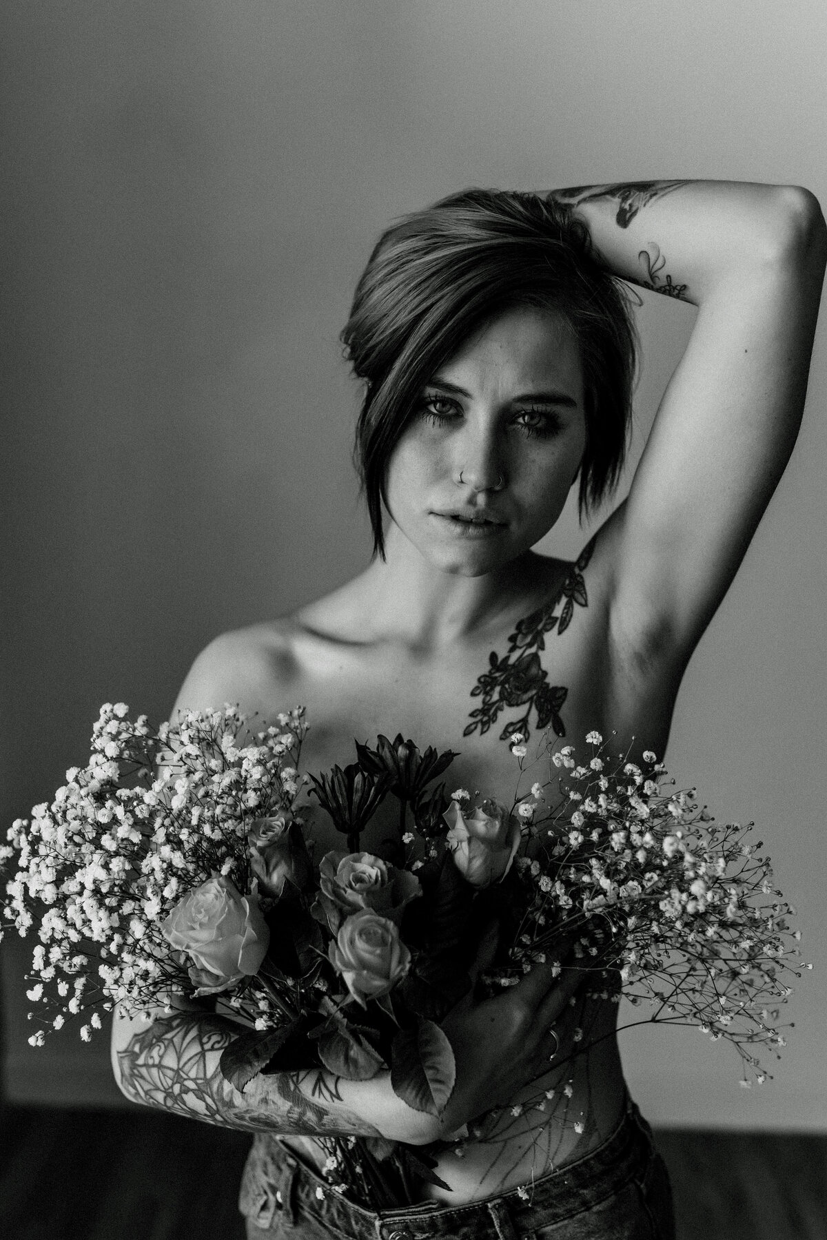 woman holding florals while posing in front of camera