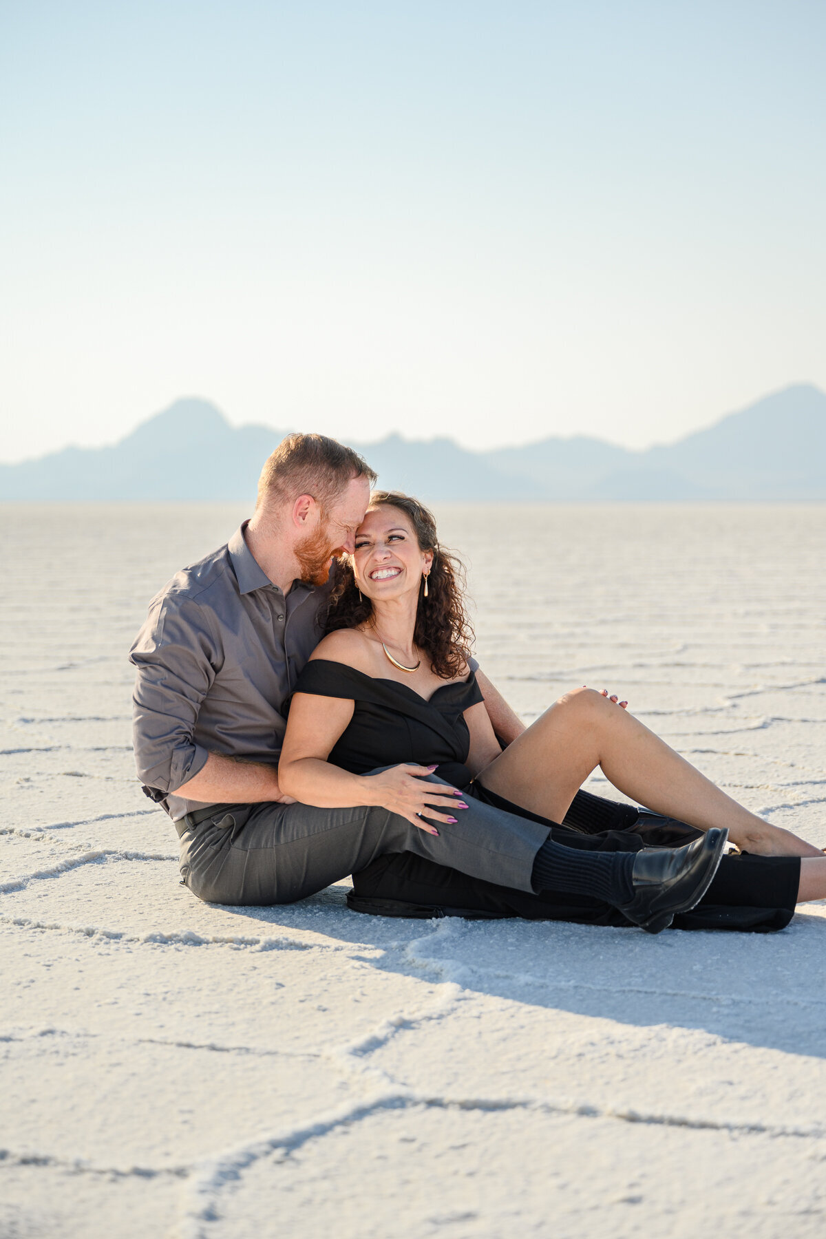 couple sitting in slat flats utah for engagement phtoos