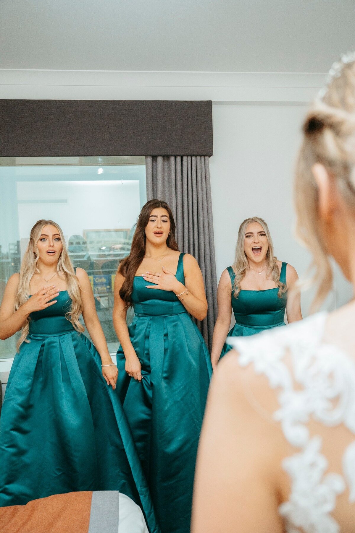 Bride's first look with bridesmaids – teal dresses, Liverpool wedding.