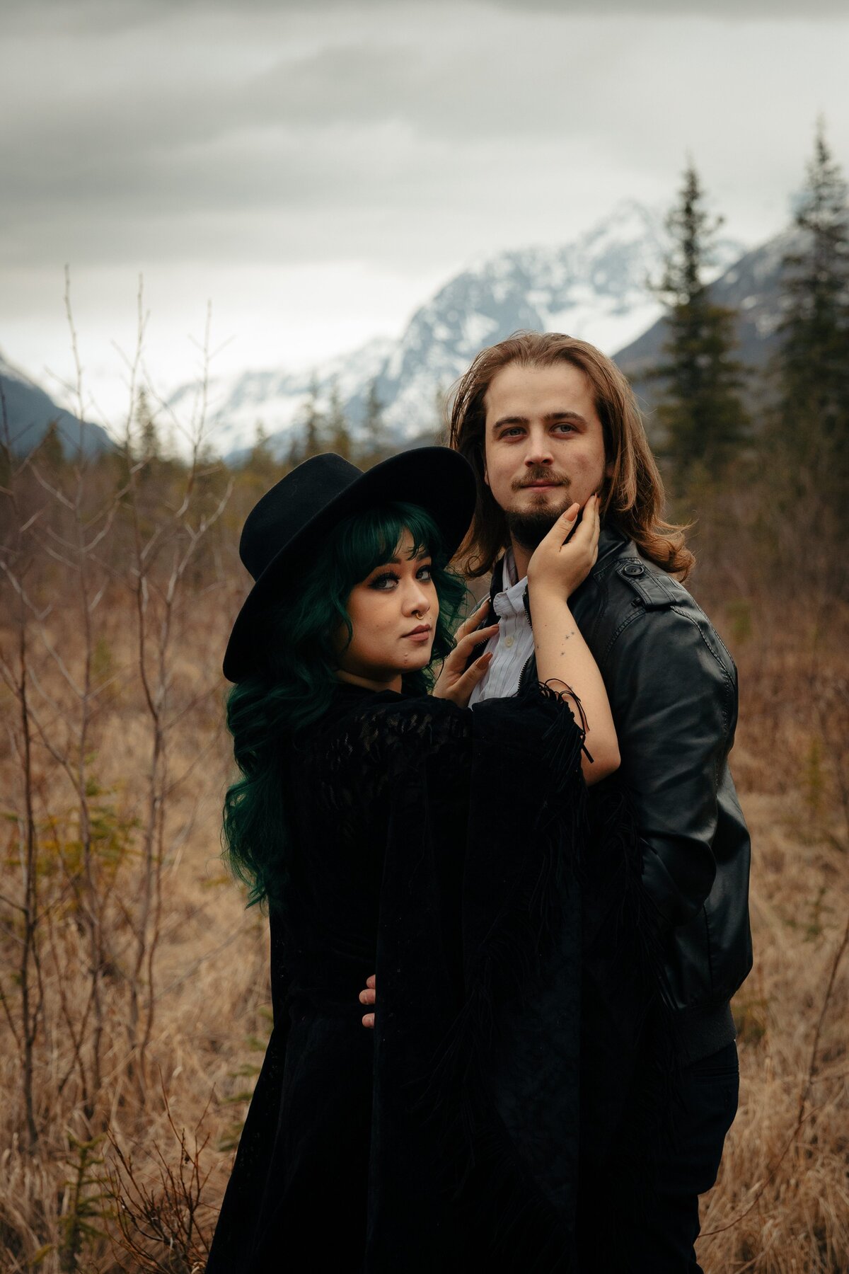 An alaskan couple embraces during an early spring elopement in Eagle River, Alaska