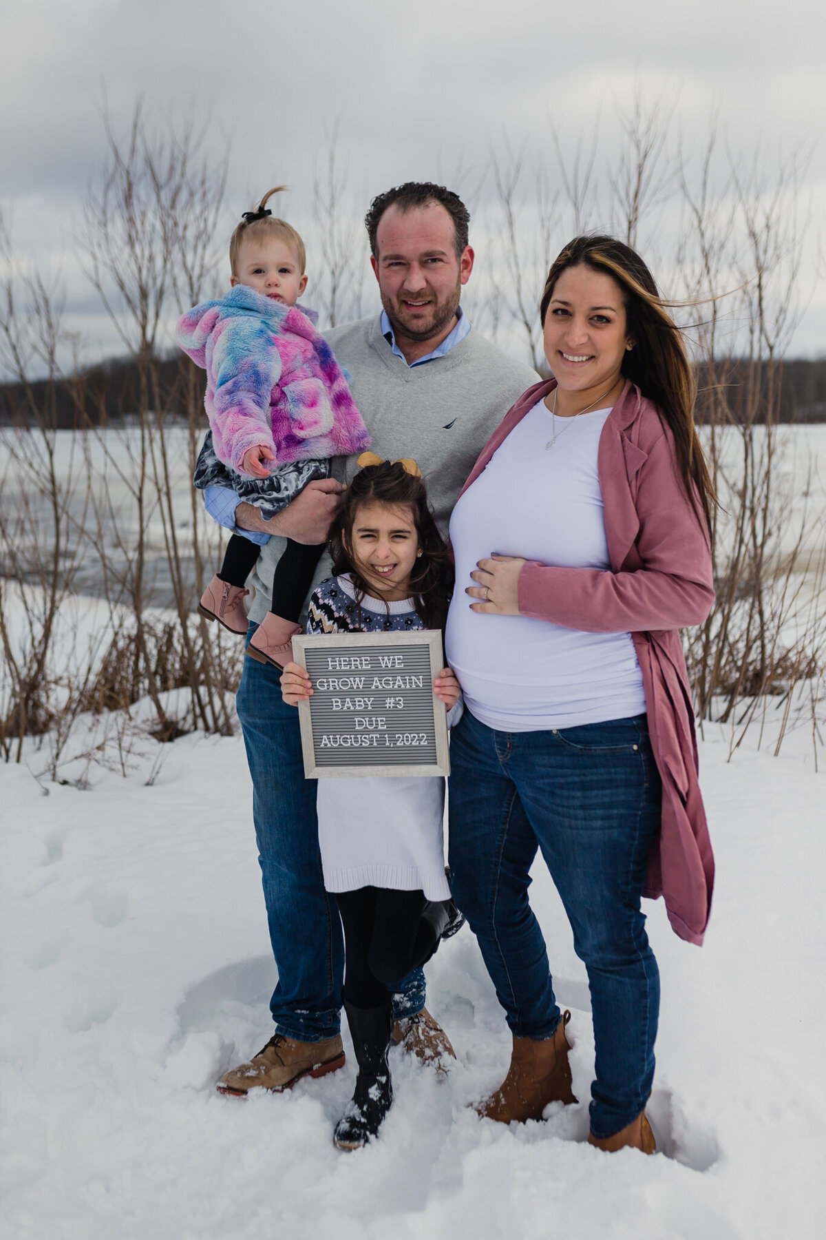 Pregnancy photograph with mom, dad, and two children.