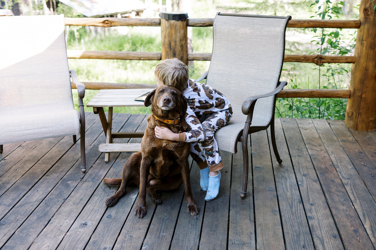 Boy hugging a dog