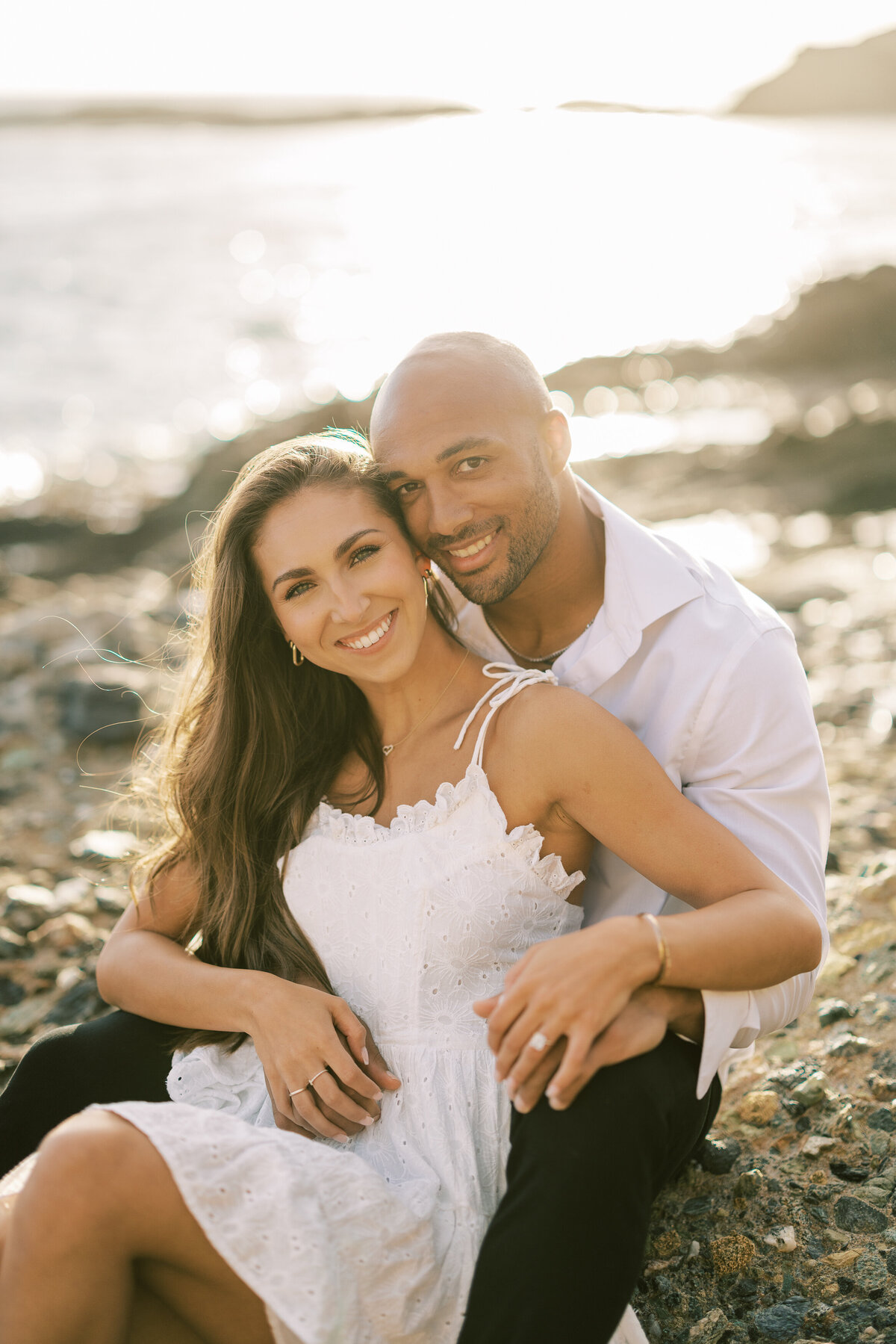 smiling engagement photo on the beach