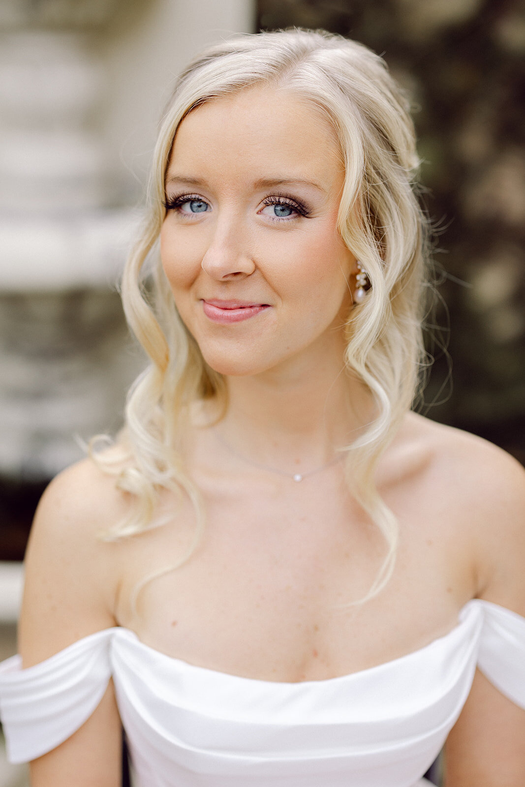 bride close up smiling in front of a fountain shot by Philadelphia photographer.
