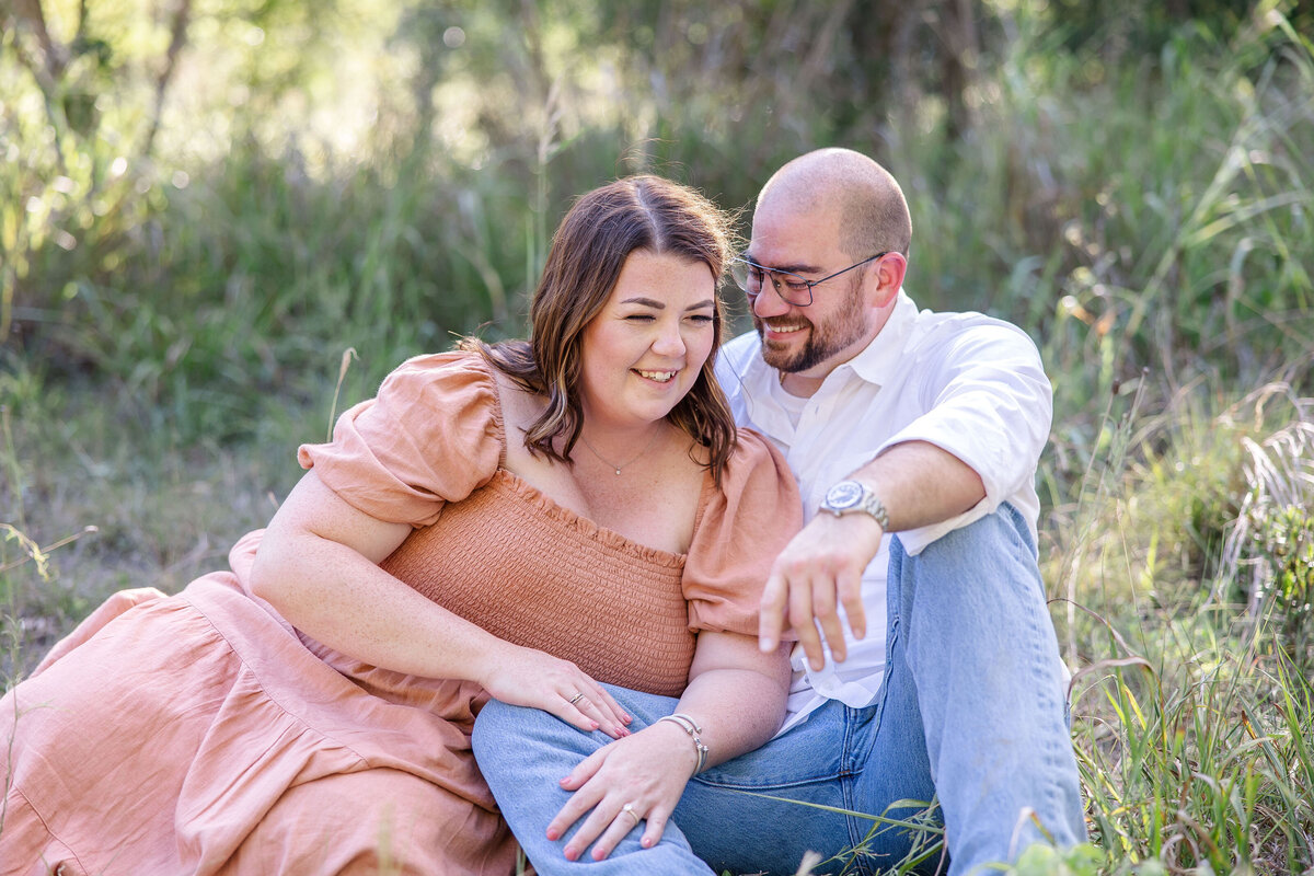 couple laughing in field in Boerne Texas  wedding engagement by Firefly Photography