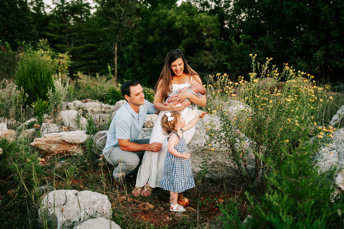 family playing on rocks during family photography session in Springfield MO