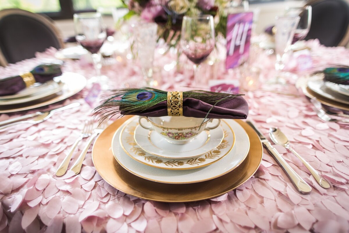 table setting on pink tablecloth at club at hillbrook 
