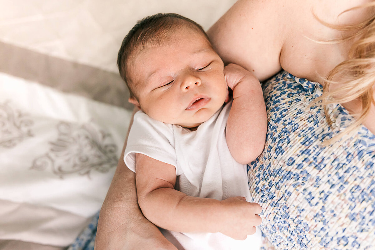 Baby boy being held by Mom