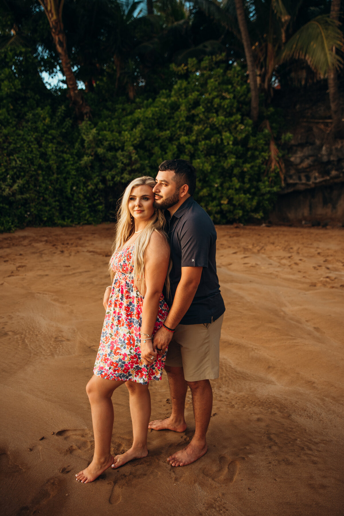 Hawaii Engagement Photographer captures man holding woman's hand during beach engagements