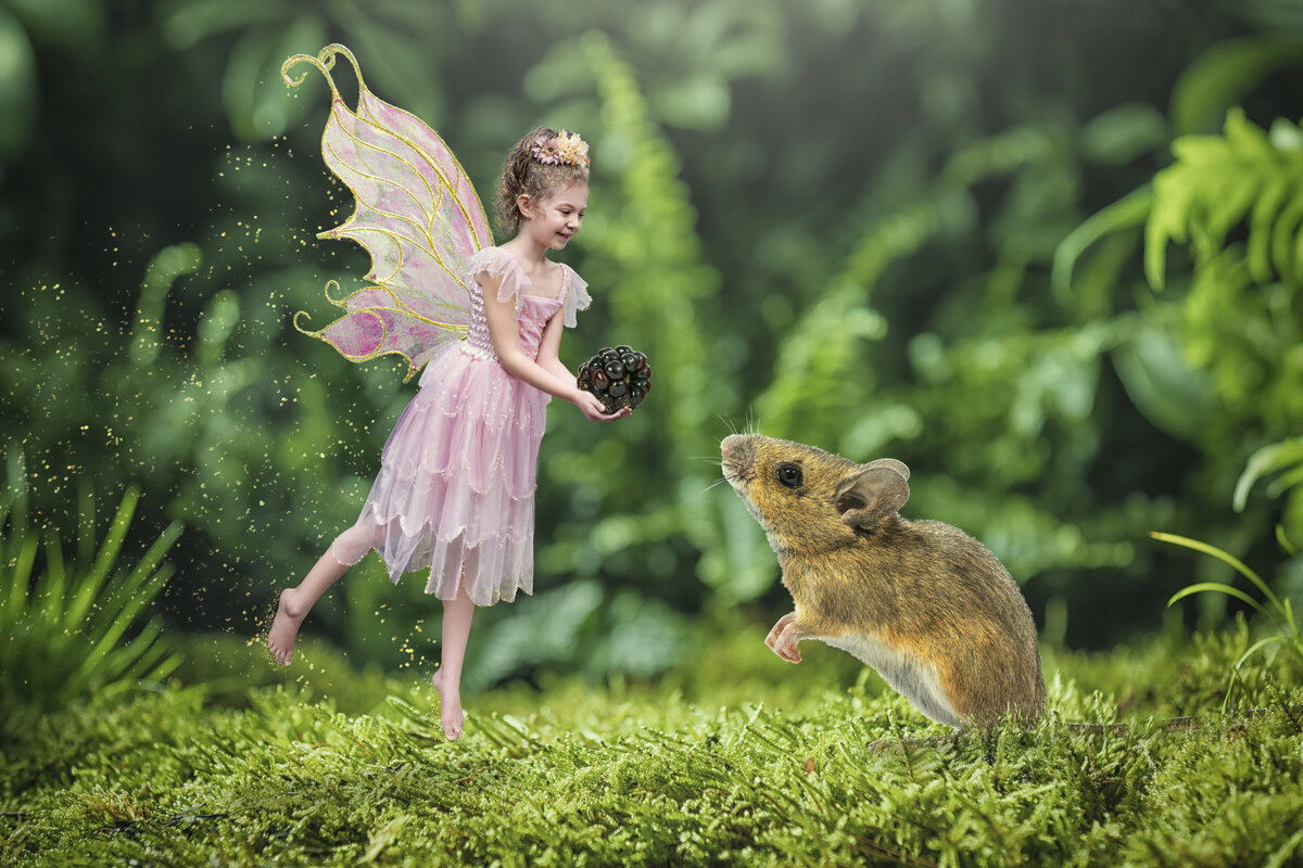 Little girl fairy flying to a small mouse