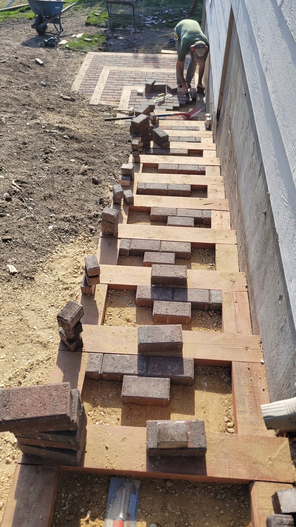 Paving professionals lay out bricks for a stairway in Missoula, Montana. 