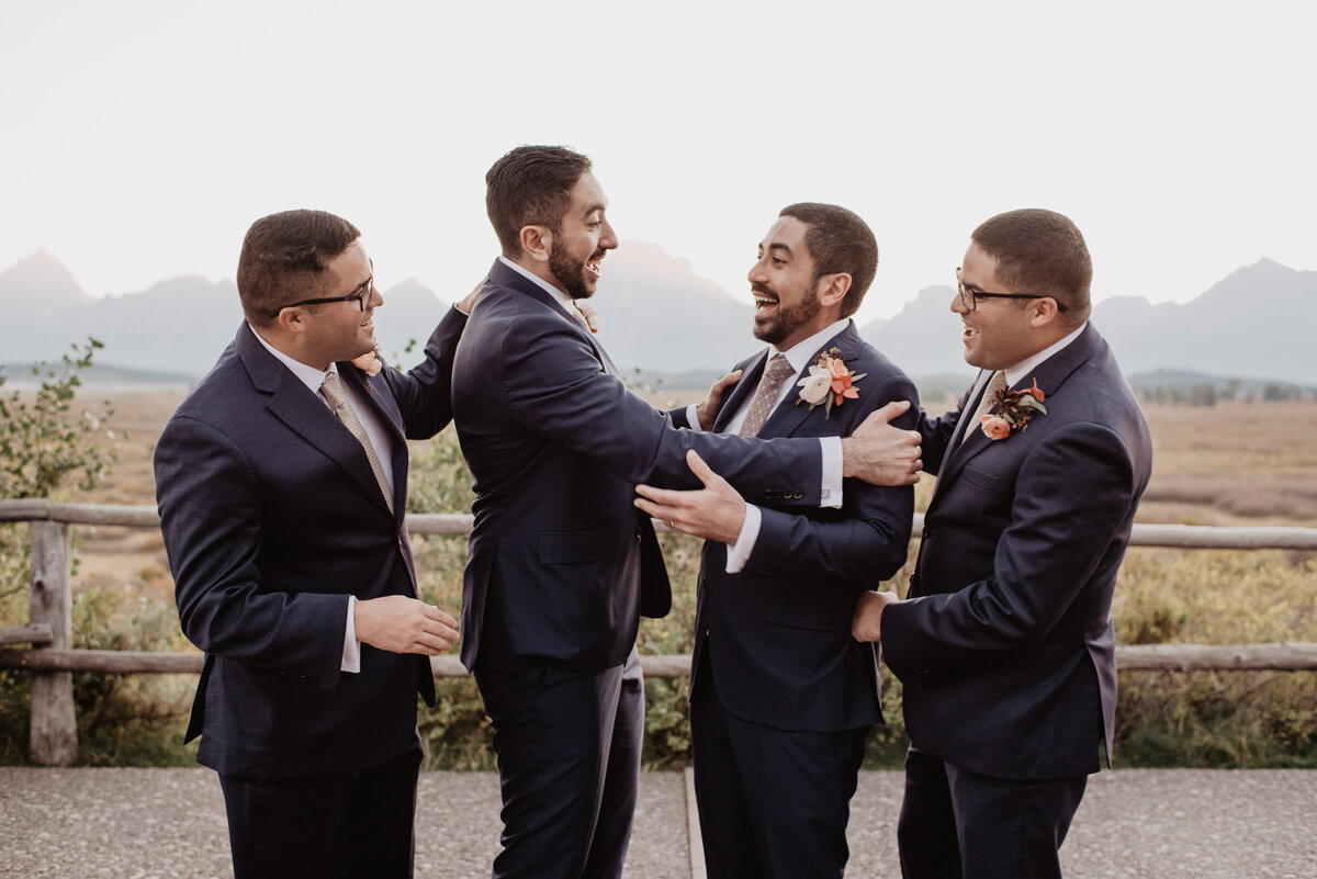 Photographers Jackson Hole capture groomsmen celebrating with groom