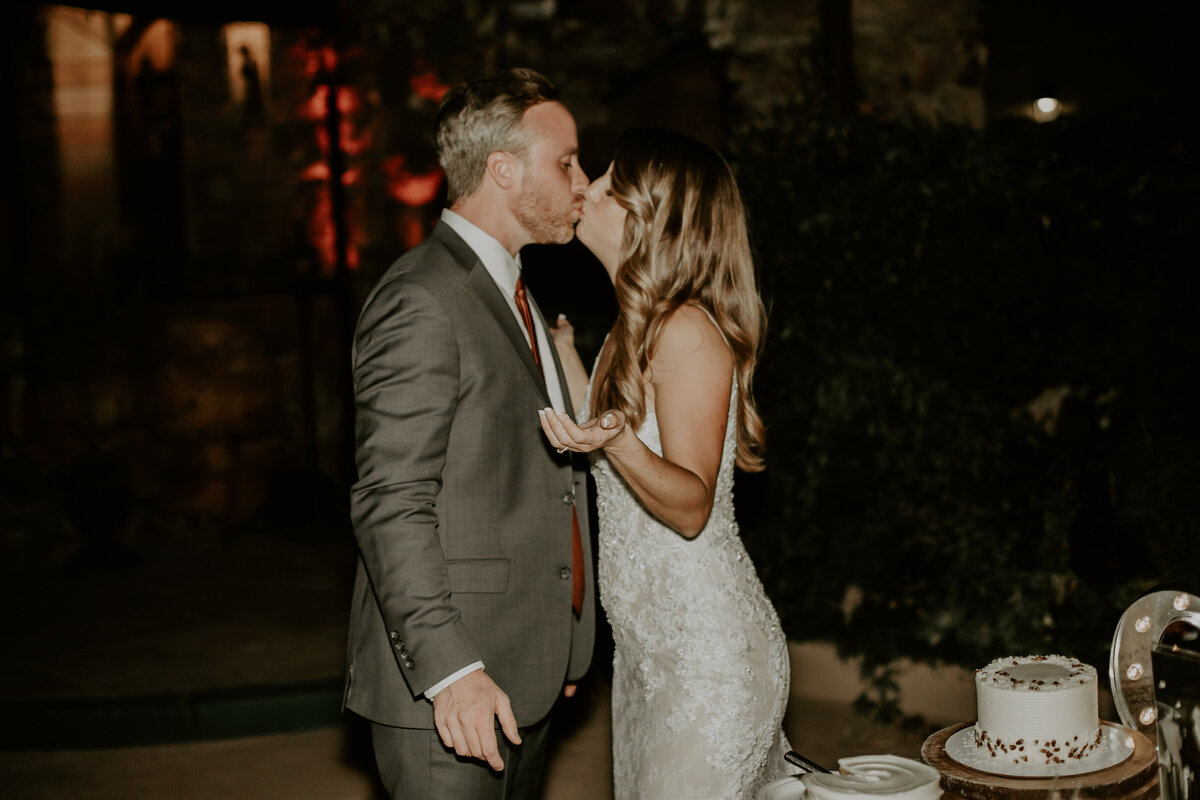 Bride and groom share a kiss during their wedding reception.