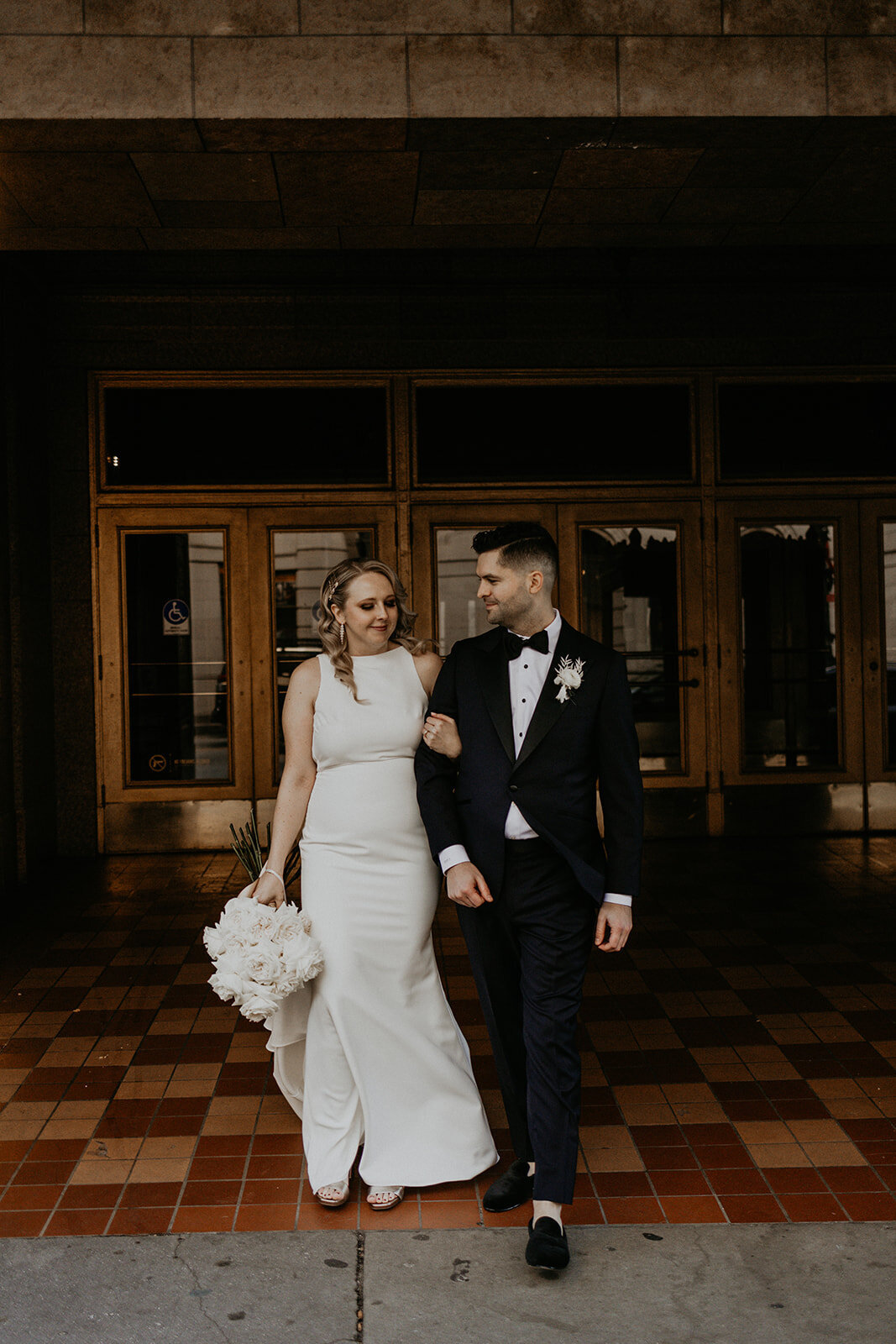 bride and groom in front of the Tennessee theater