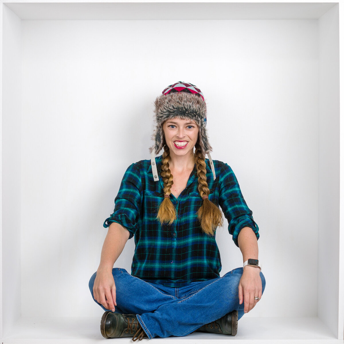 Headshot and branding photographer Jen wearing a cute hat from Fox & Brazen in  a white box