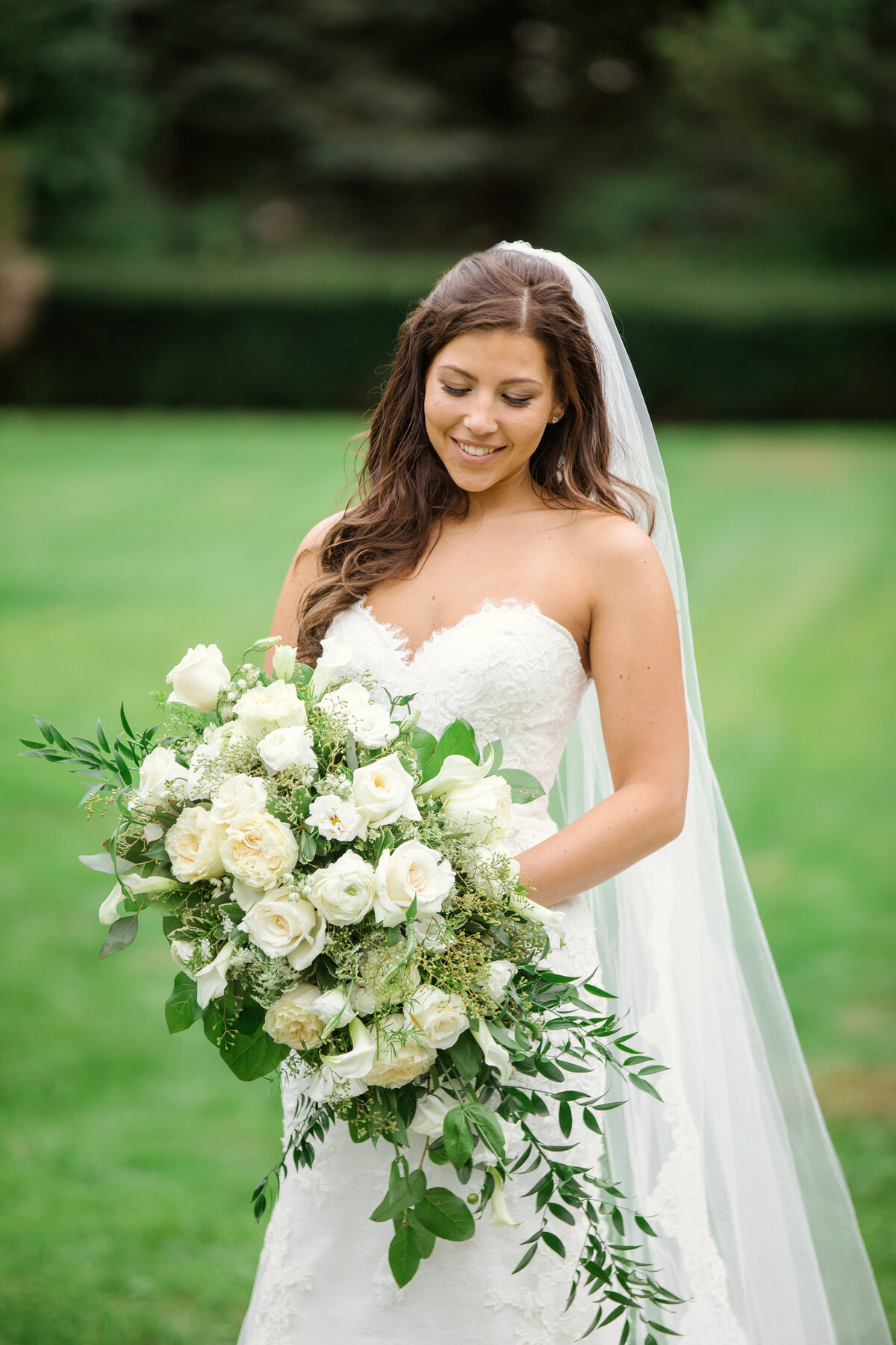 photo of bride looking down at bouquet from wedding at The Carltun