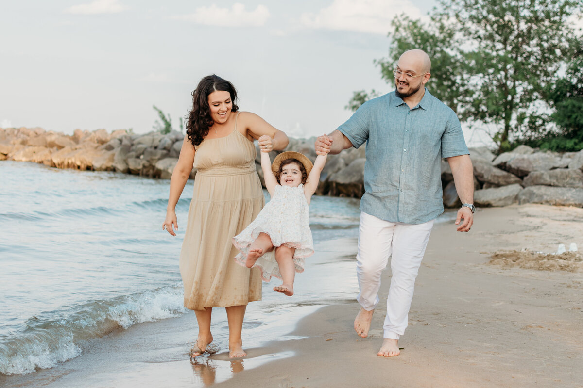 Family running by Lake Michigan during a family photoshoot, in Winnetka, IL