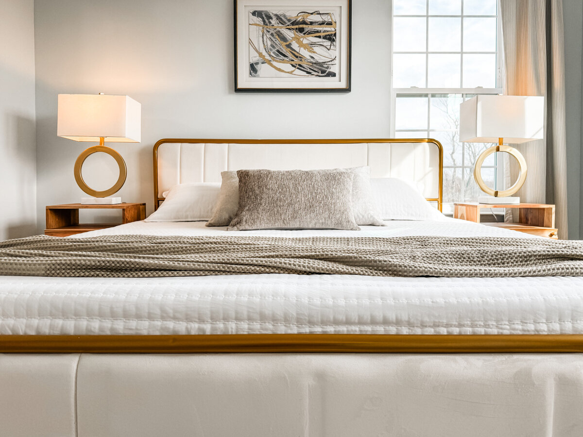Bed with neutral accents and art