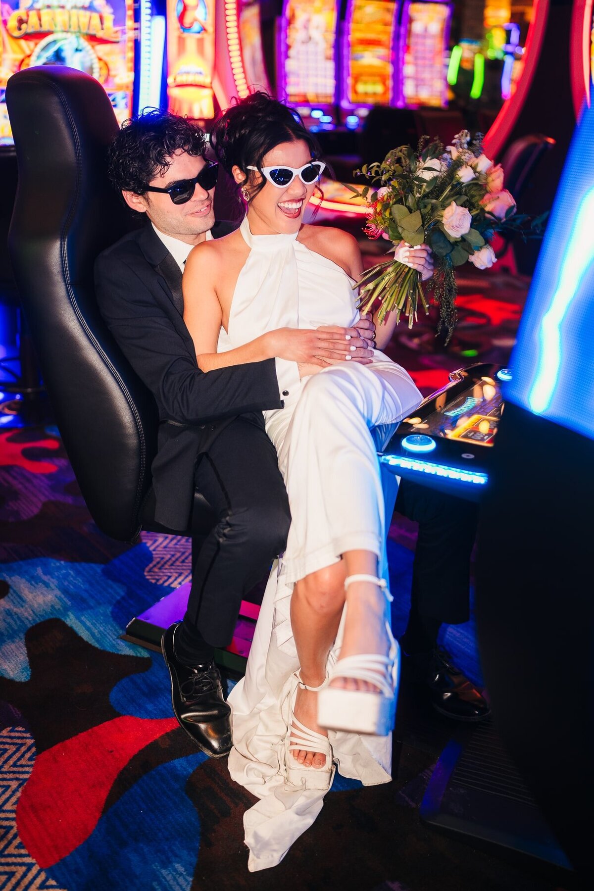 The couple playing in the casino slot machine during their elopement.