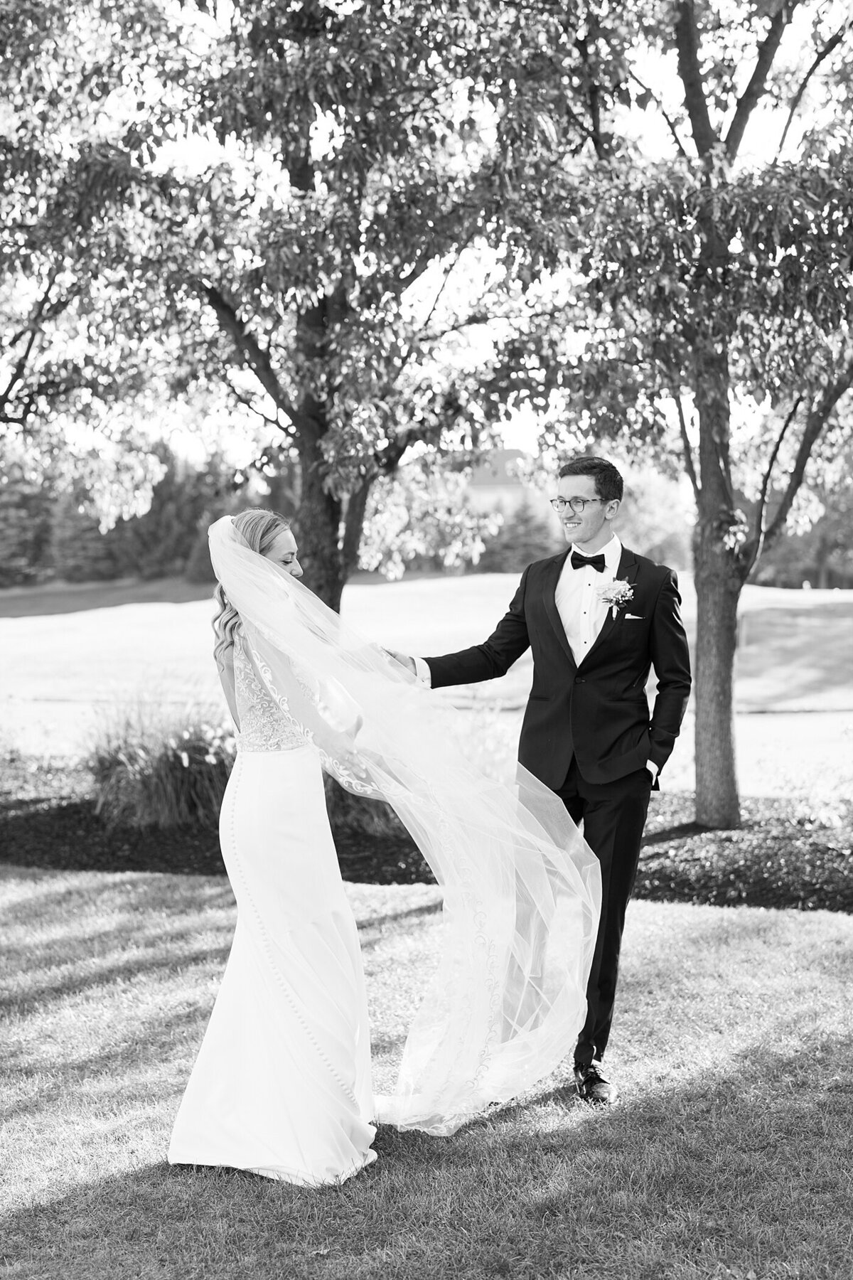 black and white wedding photo at the Pinnacle with couple dancing as the brides veil flows in the wind