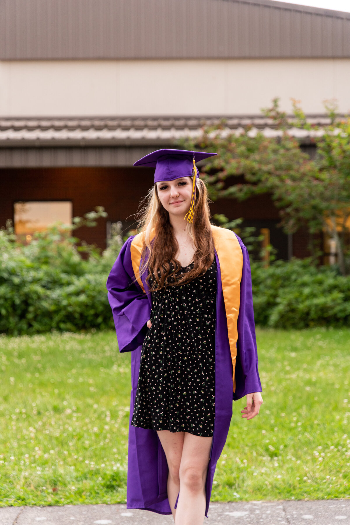 Posing for high school senior portraits in cap and gown