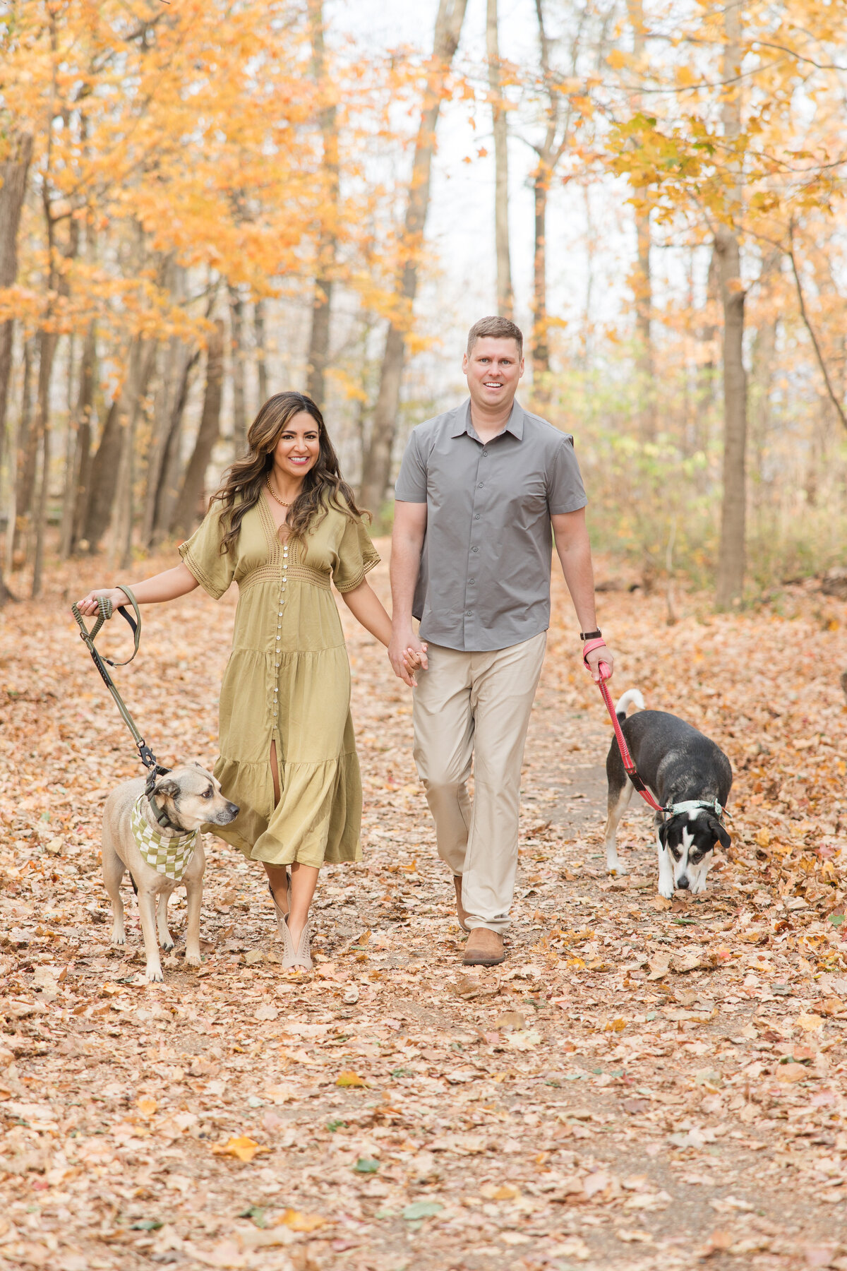 Married couple walking with their dogs