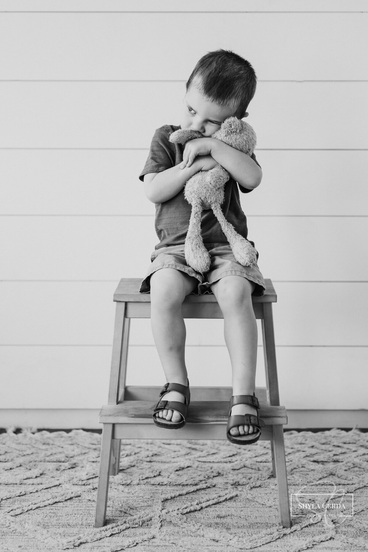 Little boy hugging his favorite stuffed toy