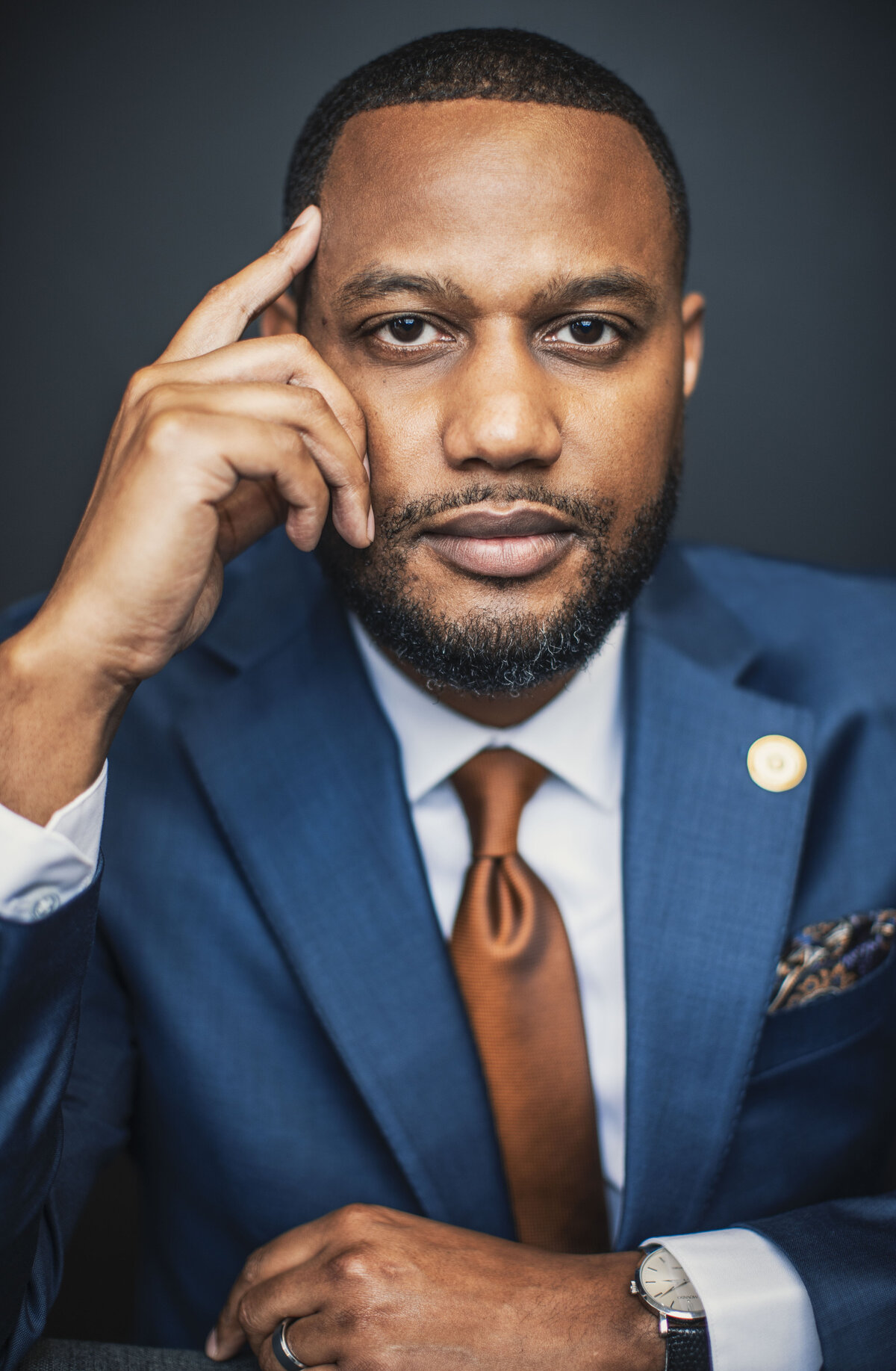 An African American black man and sales professional in a blue suit poses for a professional headshot photo on location for Janel Lee Photography studios in Cincinnati Ohio