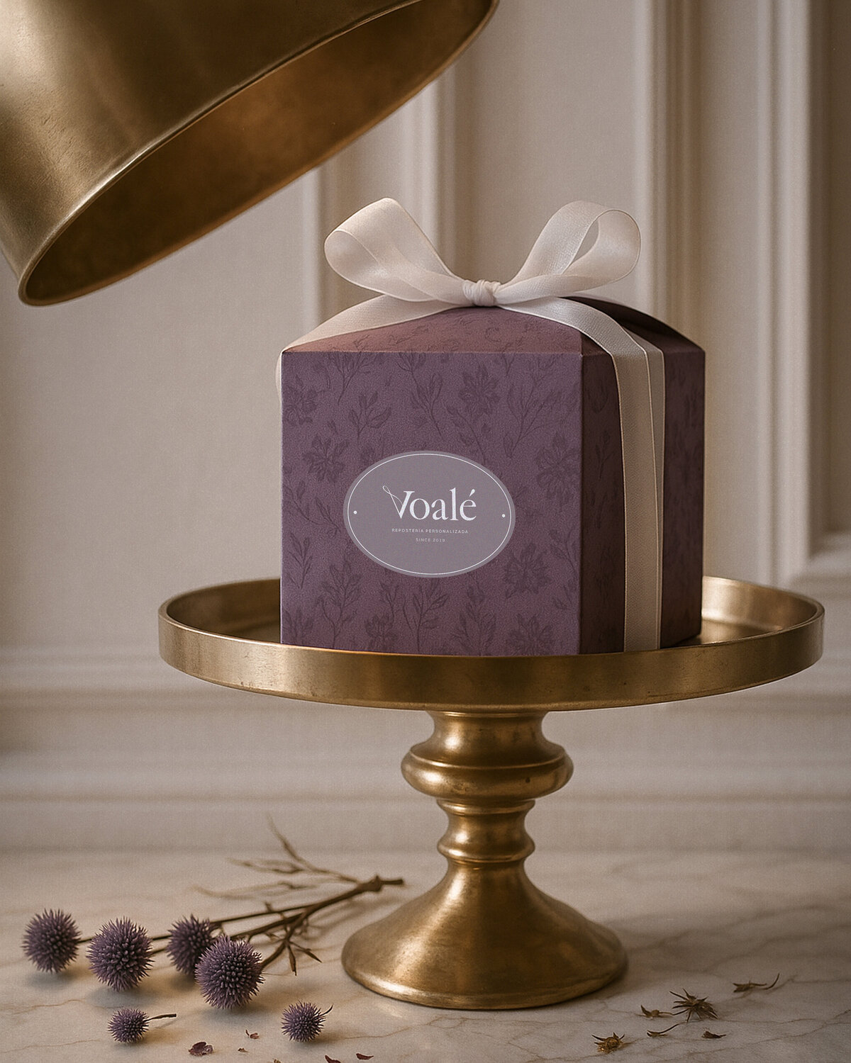Voalé packaging design with elegant purple gift box and white ribbon, showcasing timeless branding.