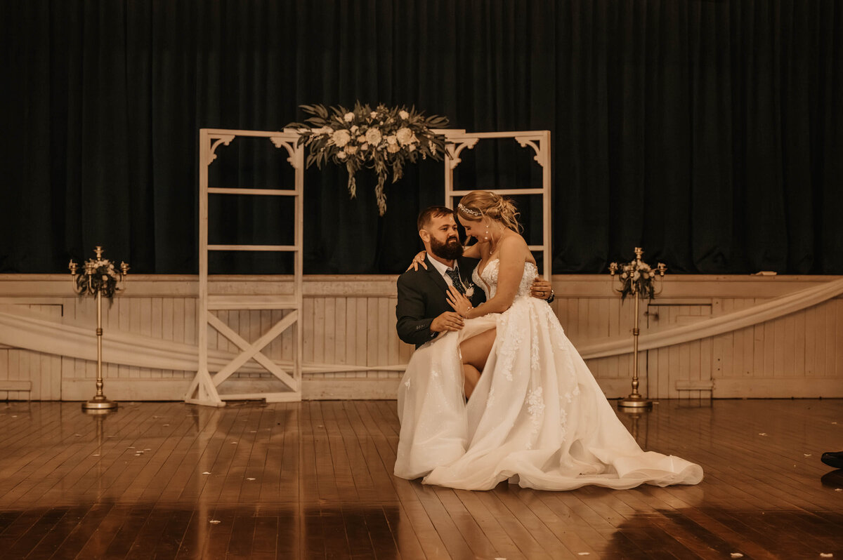 A joyful bride and groom dance closely in the heart of a room, celebrating their special moment together. - photo by Jamie Simmons