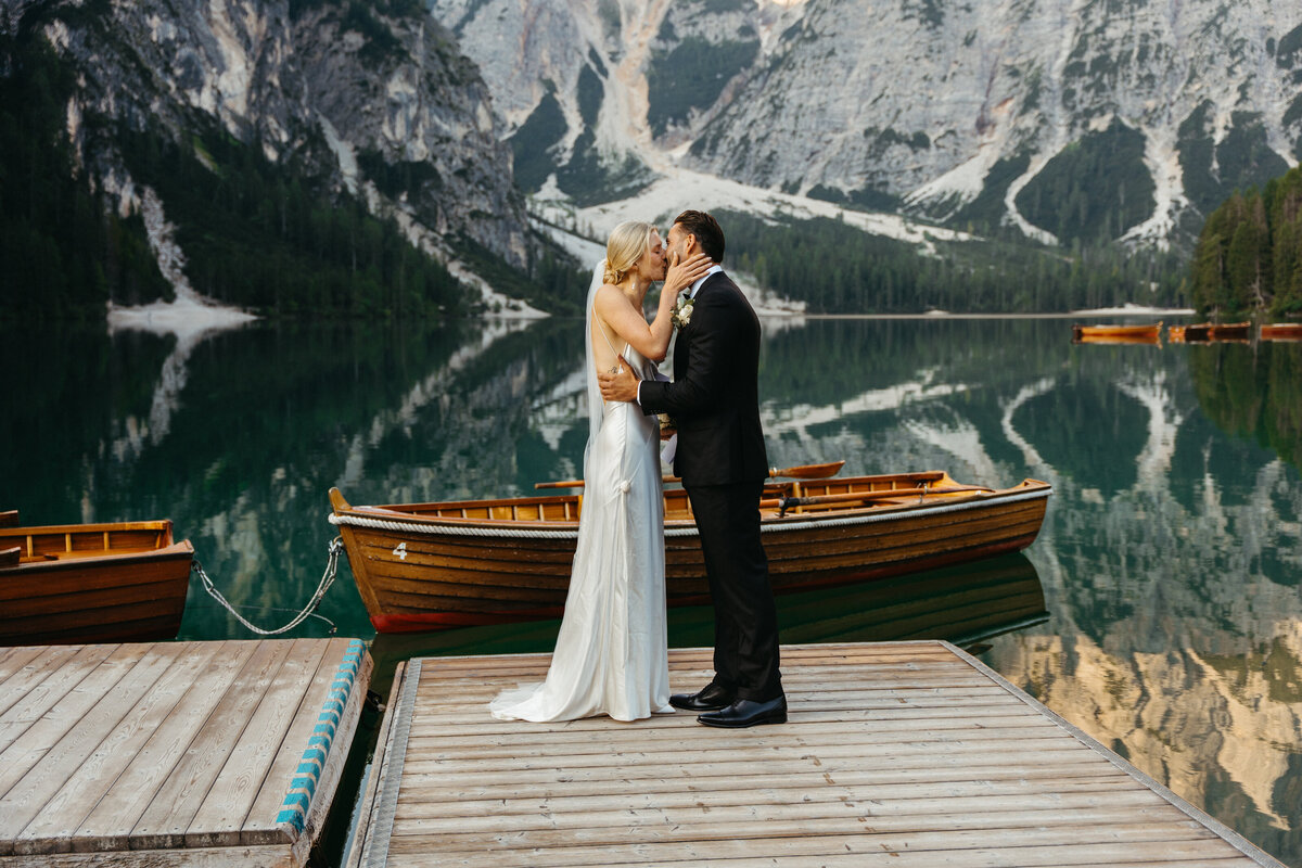 Romantic kiss between bride and groom at Lago di Braies