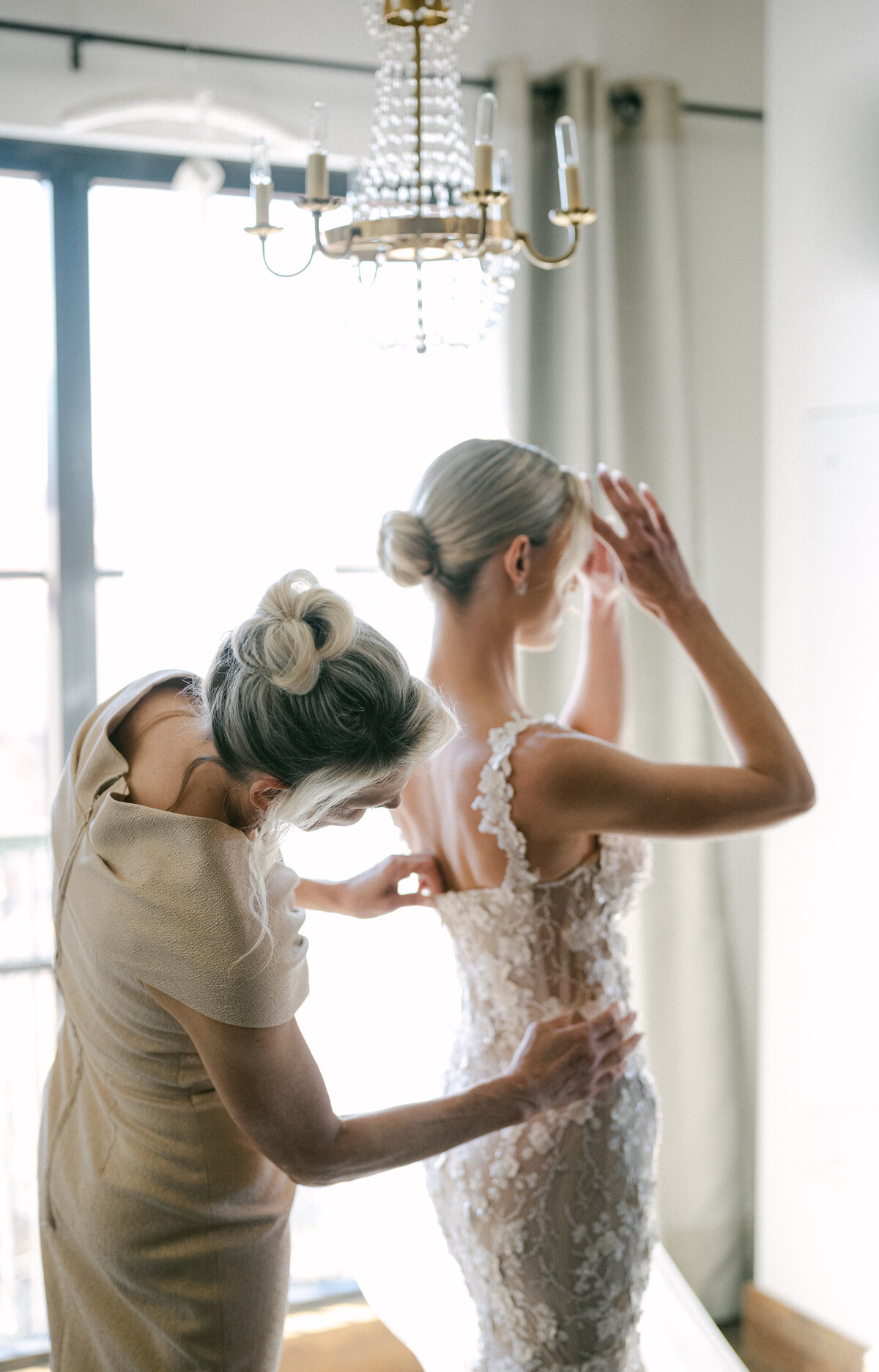 Bride getting ready at Hotel Drover in Dallas wearing a  Galia Lahav gown