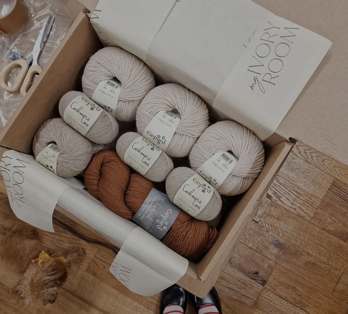 Open box with yarn and branded tissue