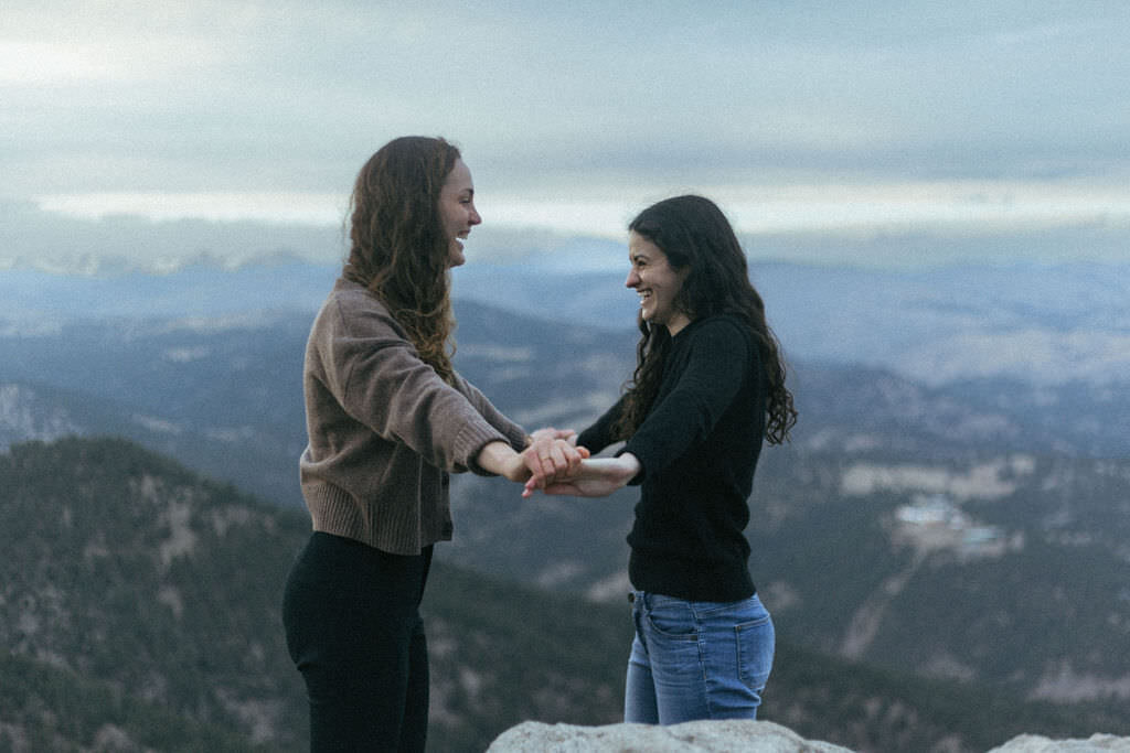 A couple holding their hands out together.