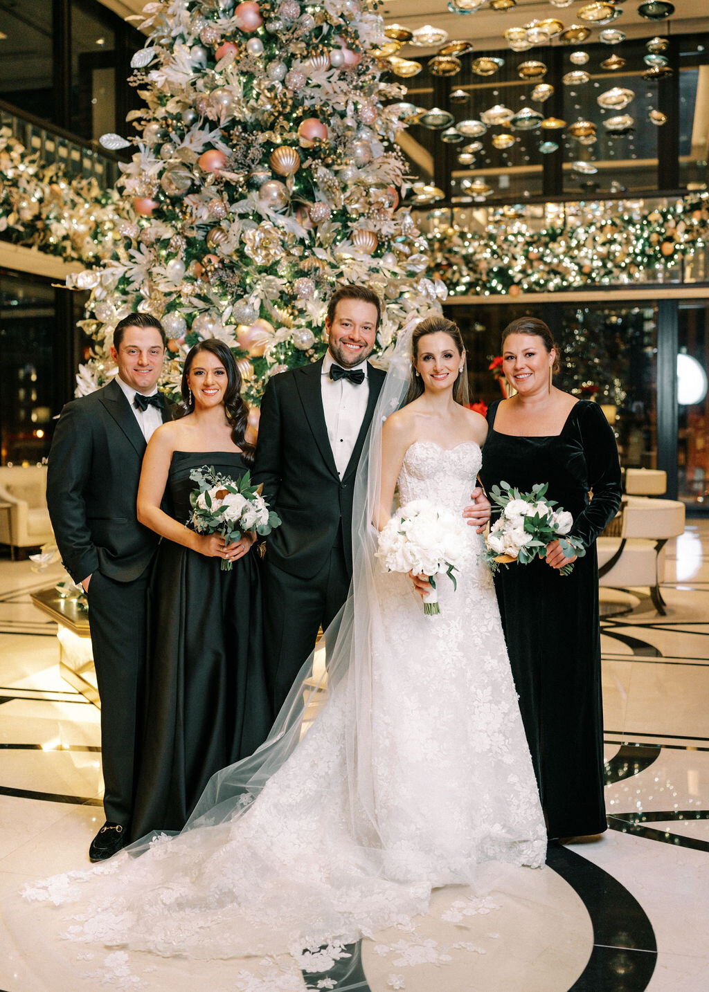 Close up photo of the bride and groom with some wedding guests.