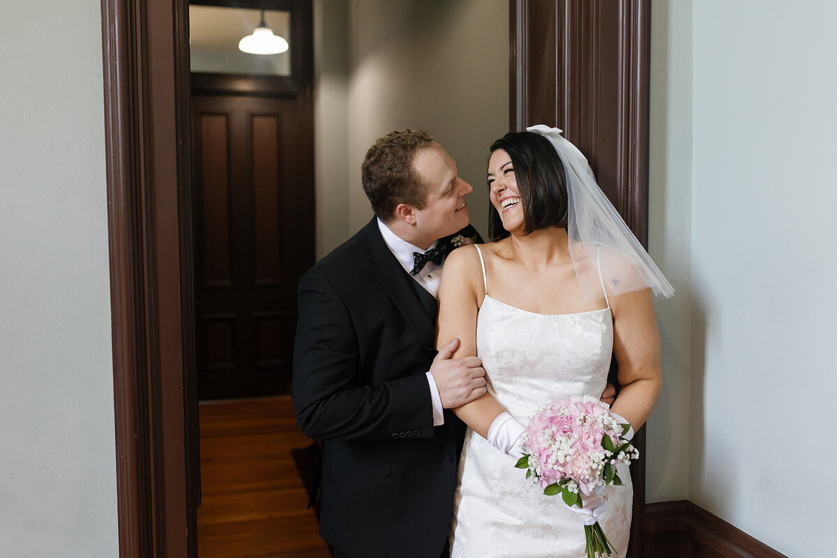 Bride and groom laughing together after DFW courthouse wedding.