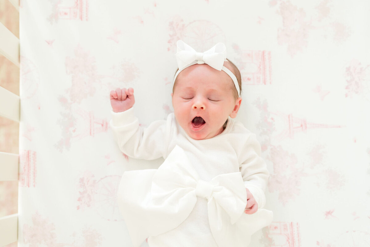 Authentic in-home newborn session with soft light and warm tones.