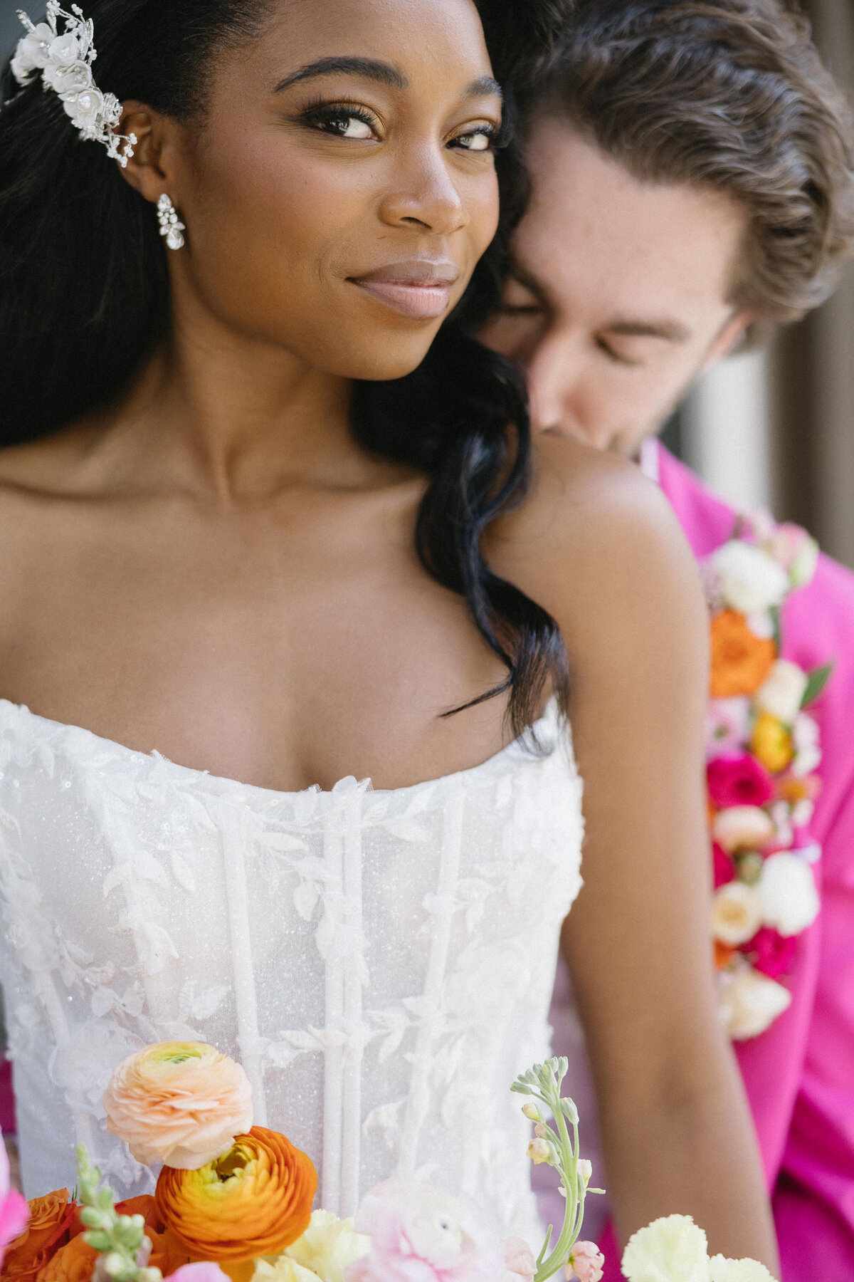Groom kissing his bride on the neck.