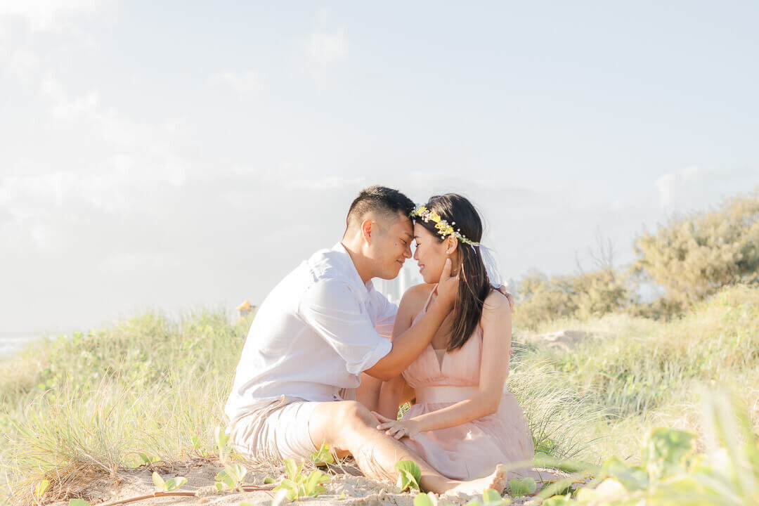 couple on sand dune at the spit gold coast having engagement photos taken