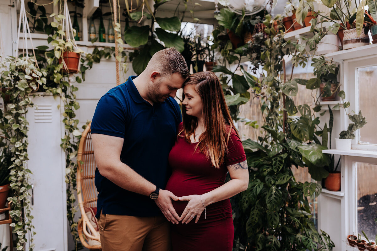 Nashville newborn photographer captures couple embracing holding pregnant belly