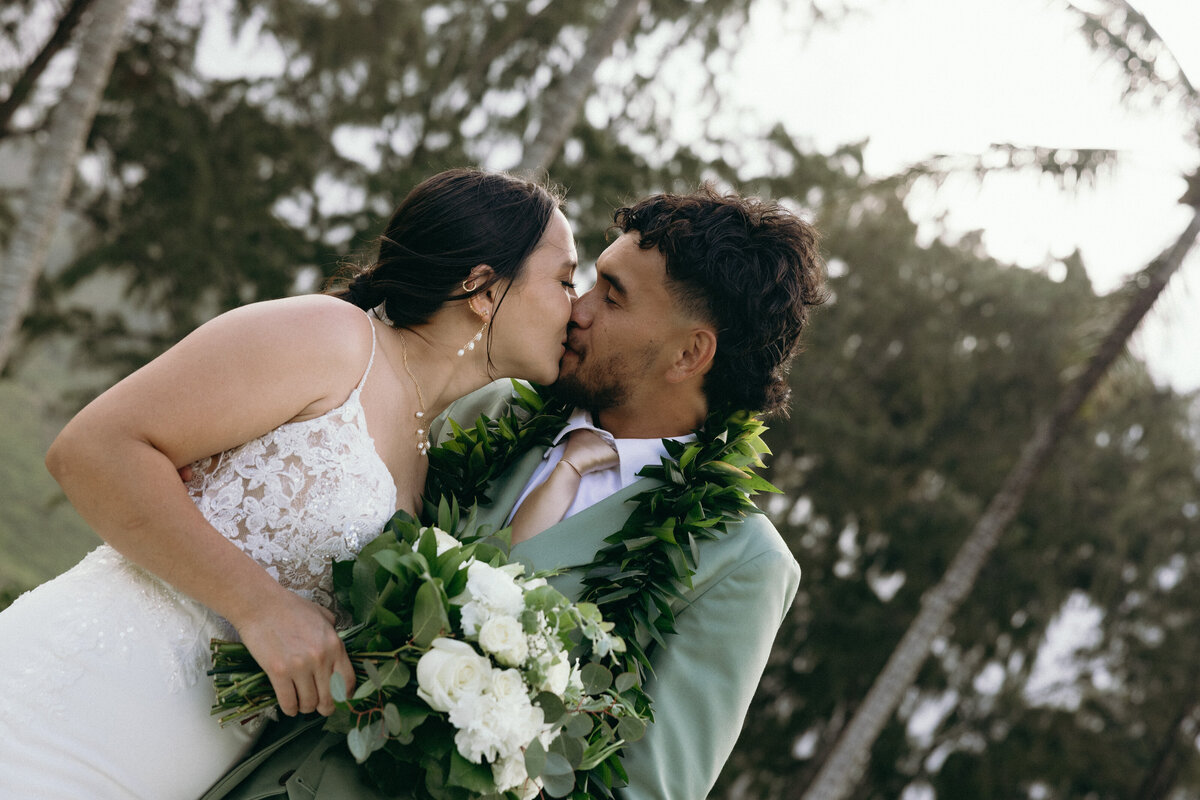 Bride and groom exchanging vows at sunset on the beach in Oahu, Hawaii