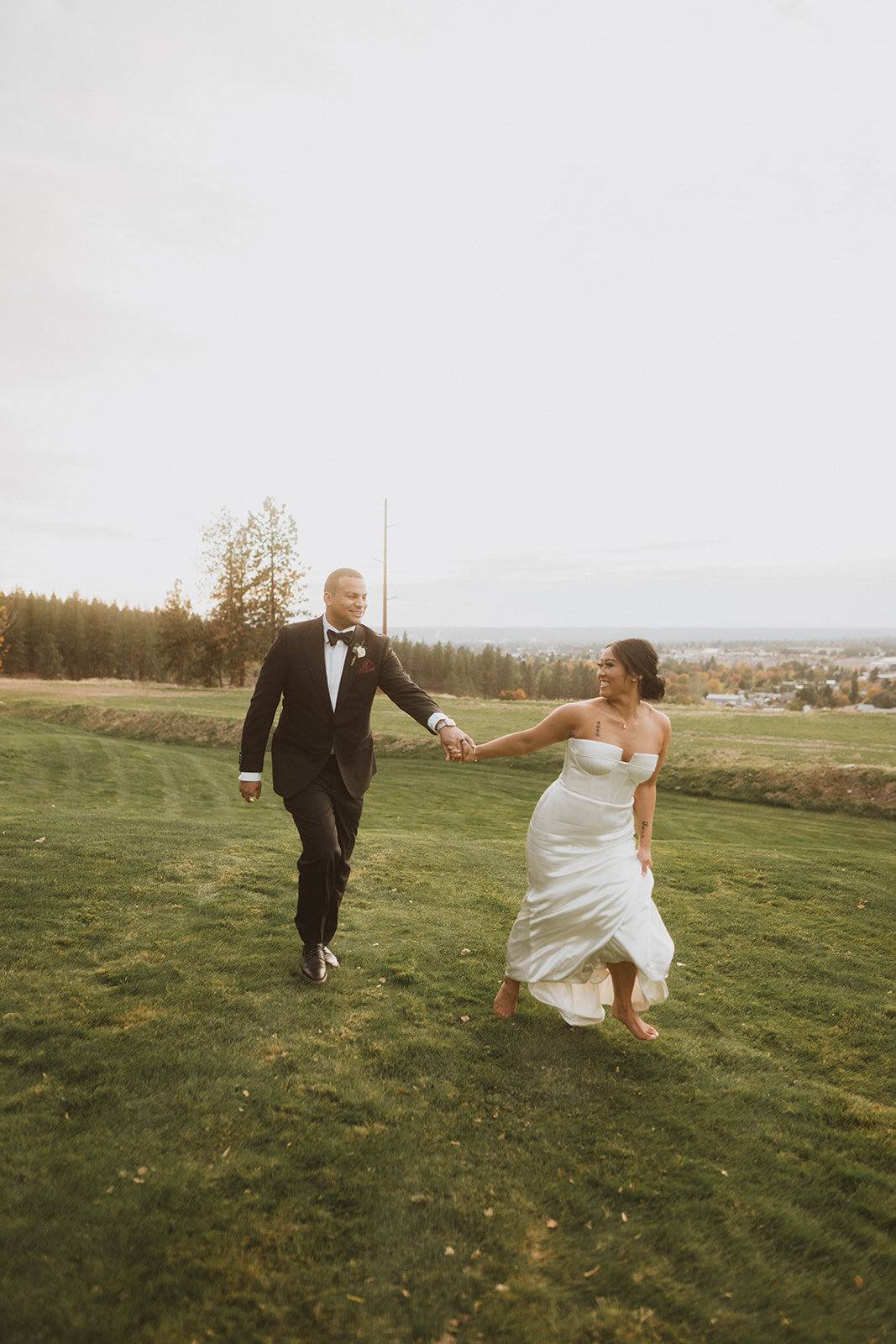 newlyweds running around on Beacon Hill during their sunset wedding photos