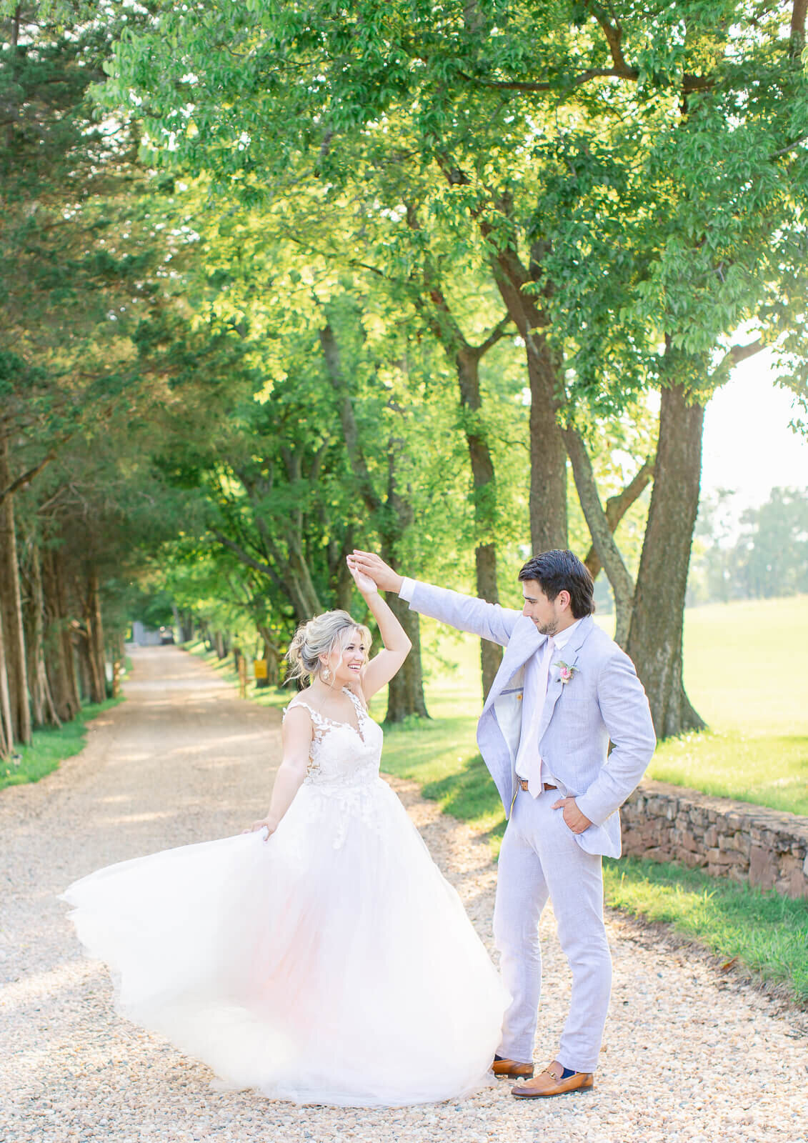 Groom twirling bride at golden hour at Great Marsh Estate. Captured by Bethany Aubre Photography.