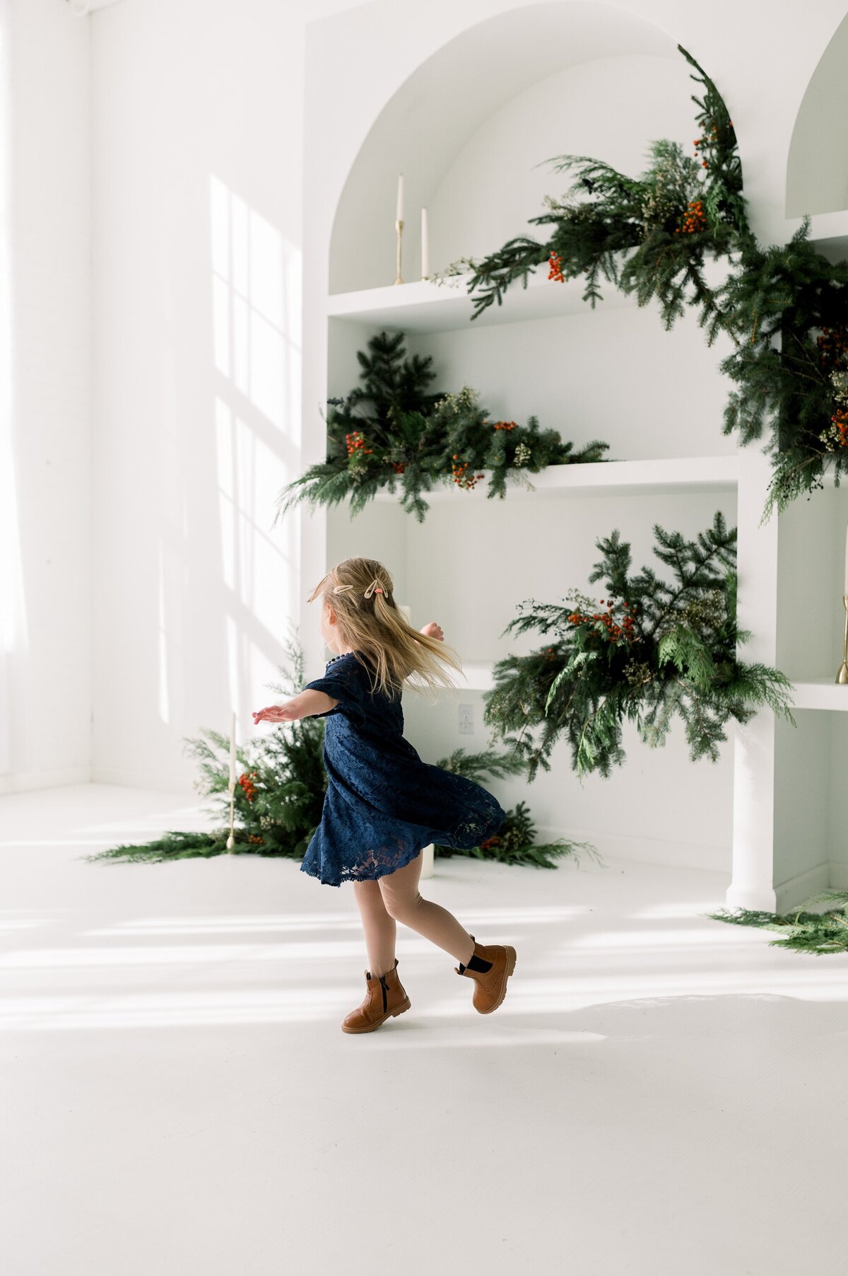 Little girl twirling in blue dress.