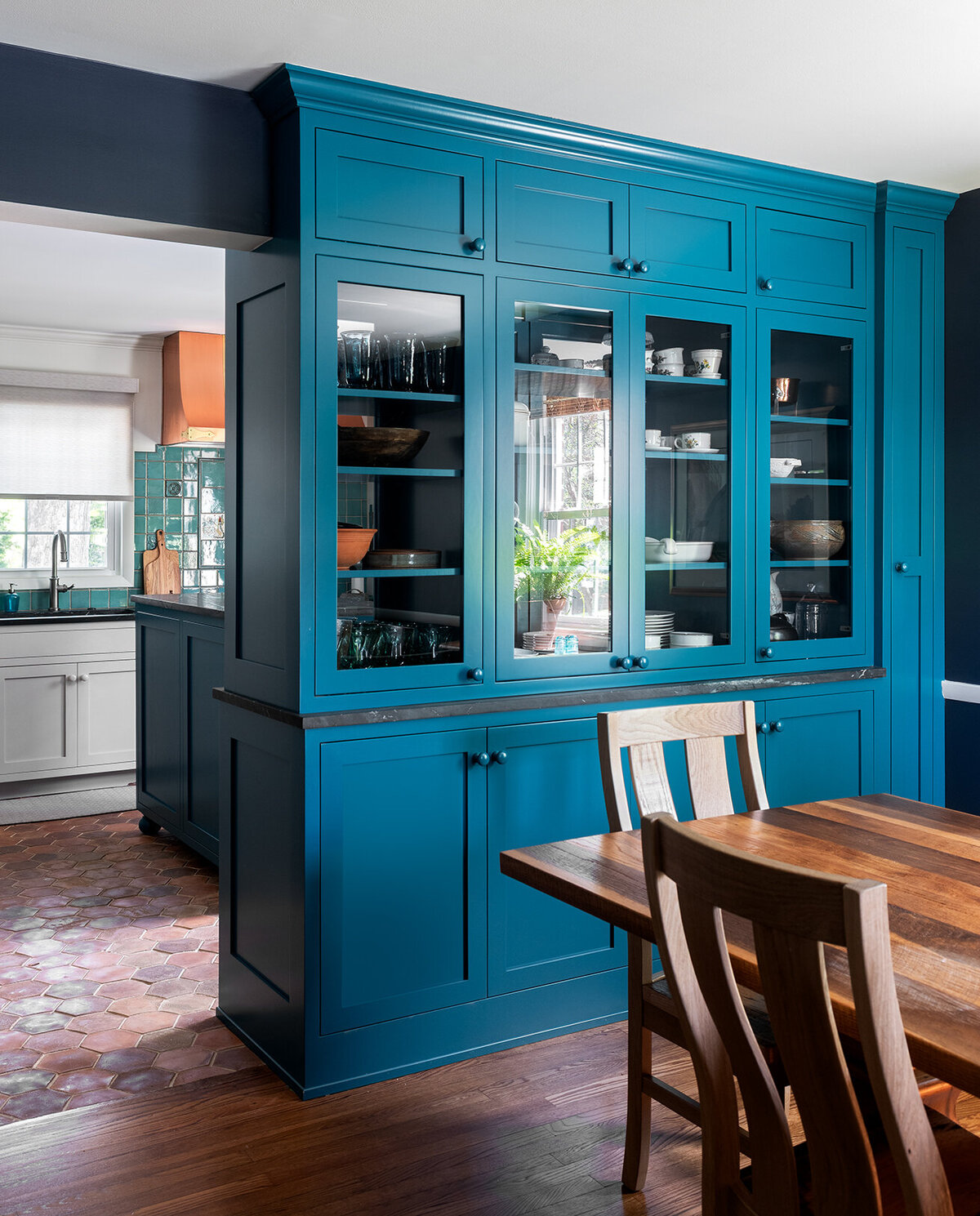 dining room with large teal china cabinet
