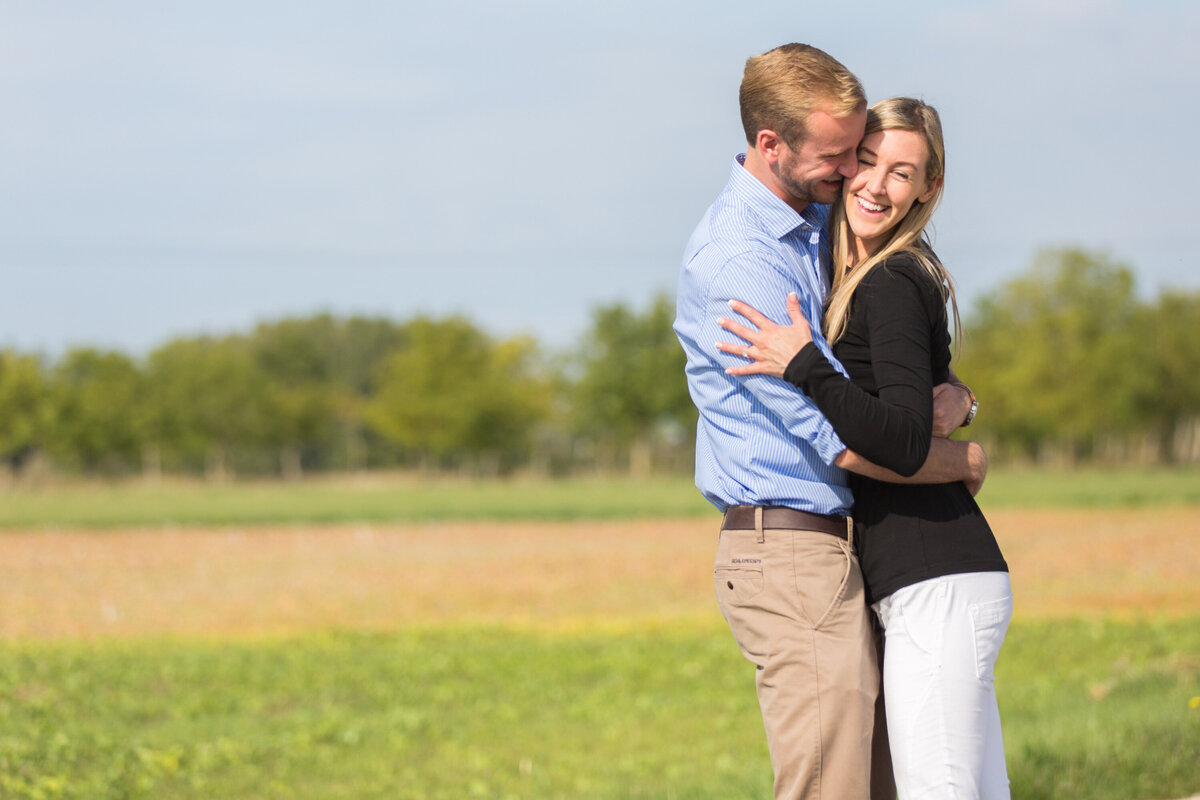 Man giving woman a hug in outdoor portrait session