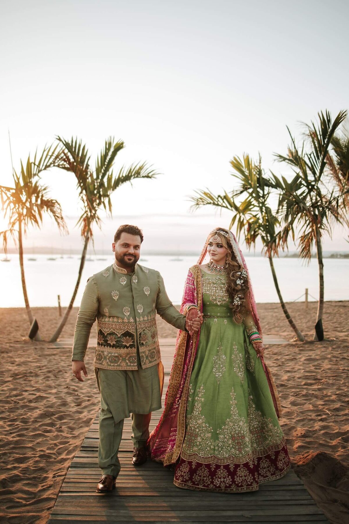 South Asian couple walking on beach during sunset in Connecticut,